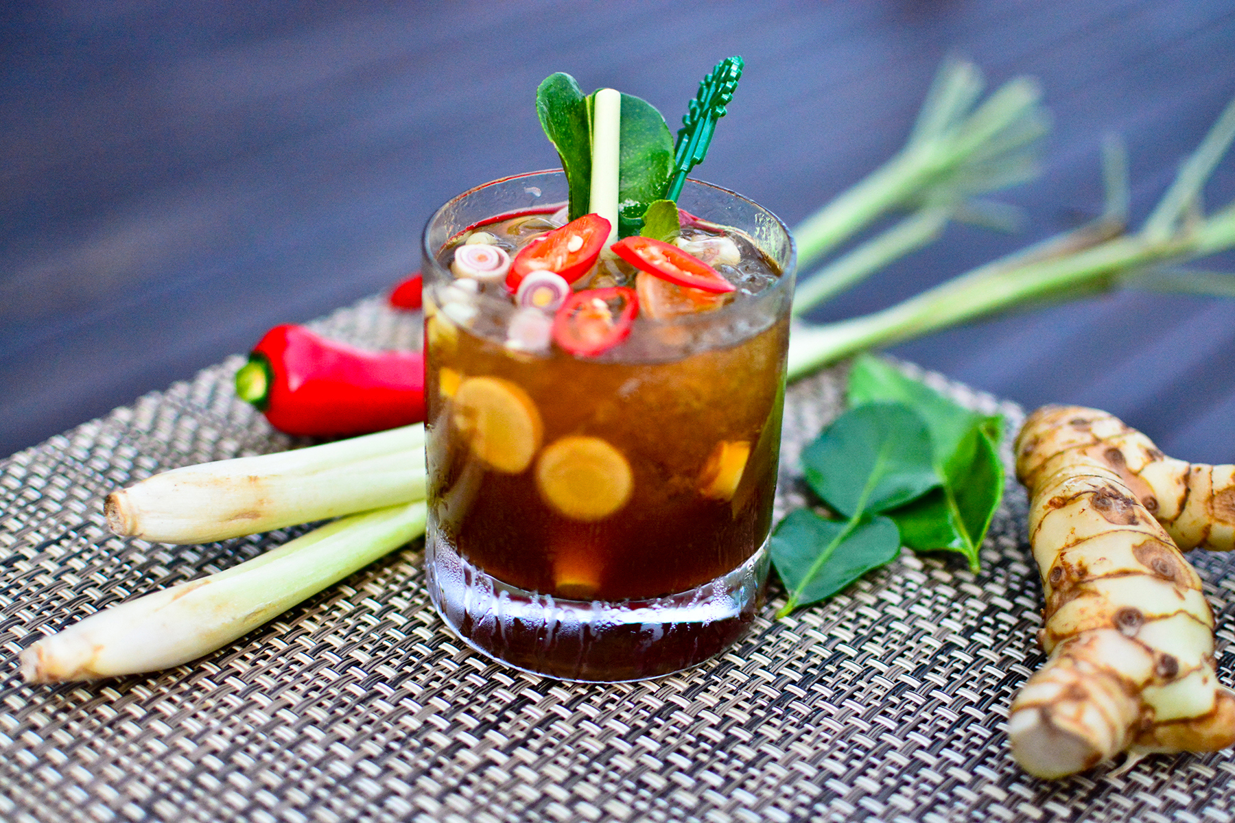 Thai cocktail with chilli garnish and ingredients 