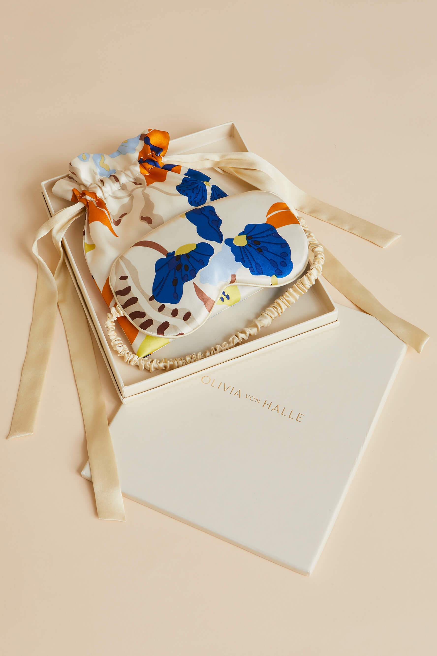 An orange and blue on cream floral print satin eye mask for sleeping