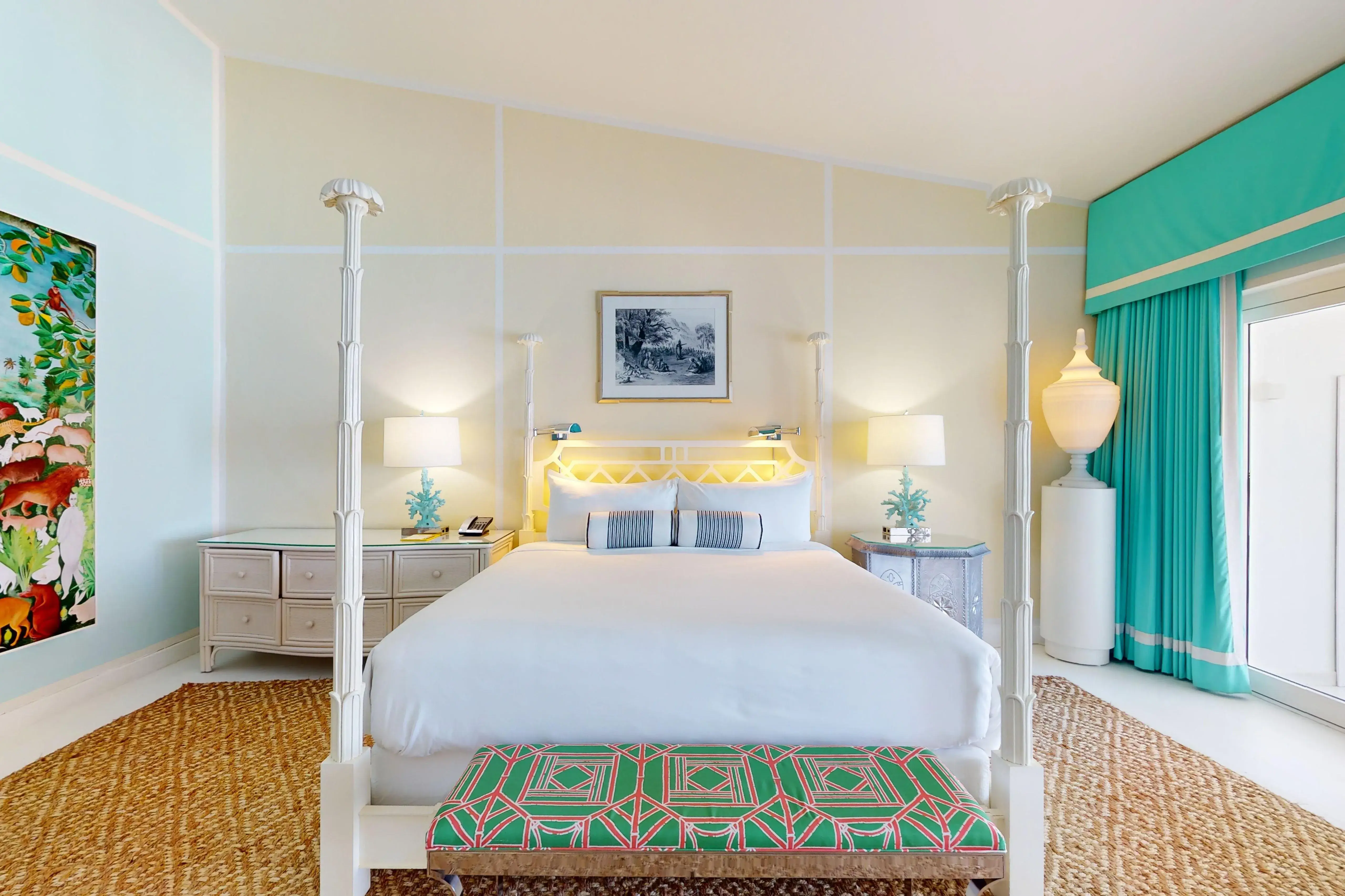 Oceanfront Junior Suite at Malliouhana Resort, Anguilla, featuring a luxurious four-poster bed, elegant Caribbean décor, and stunning seaside accommodations