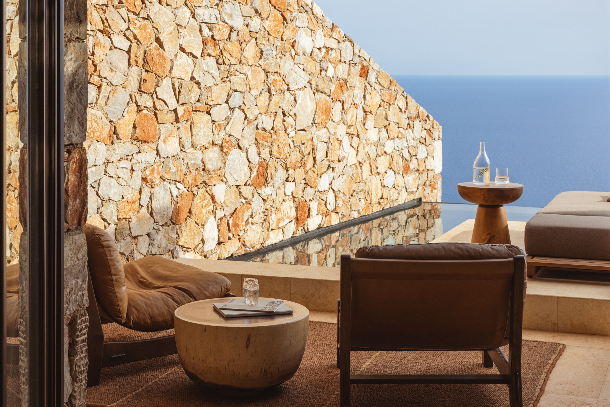 Outdoor area of a Superior Cave Suite at Gundari featuring a plunge pool and comfy seating with a view of the ocean