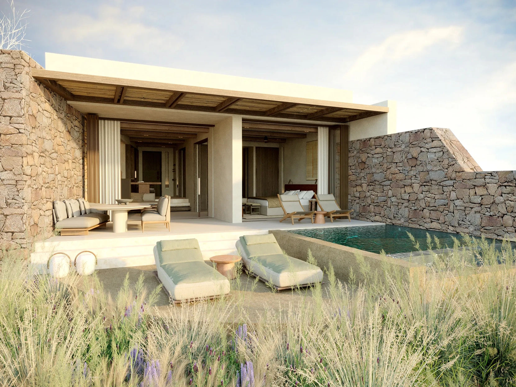 Two sun loungers and a private lunge pool in front of an open-plan villa