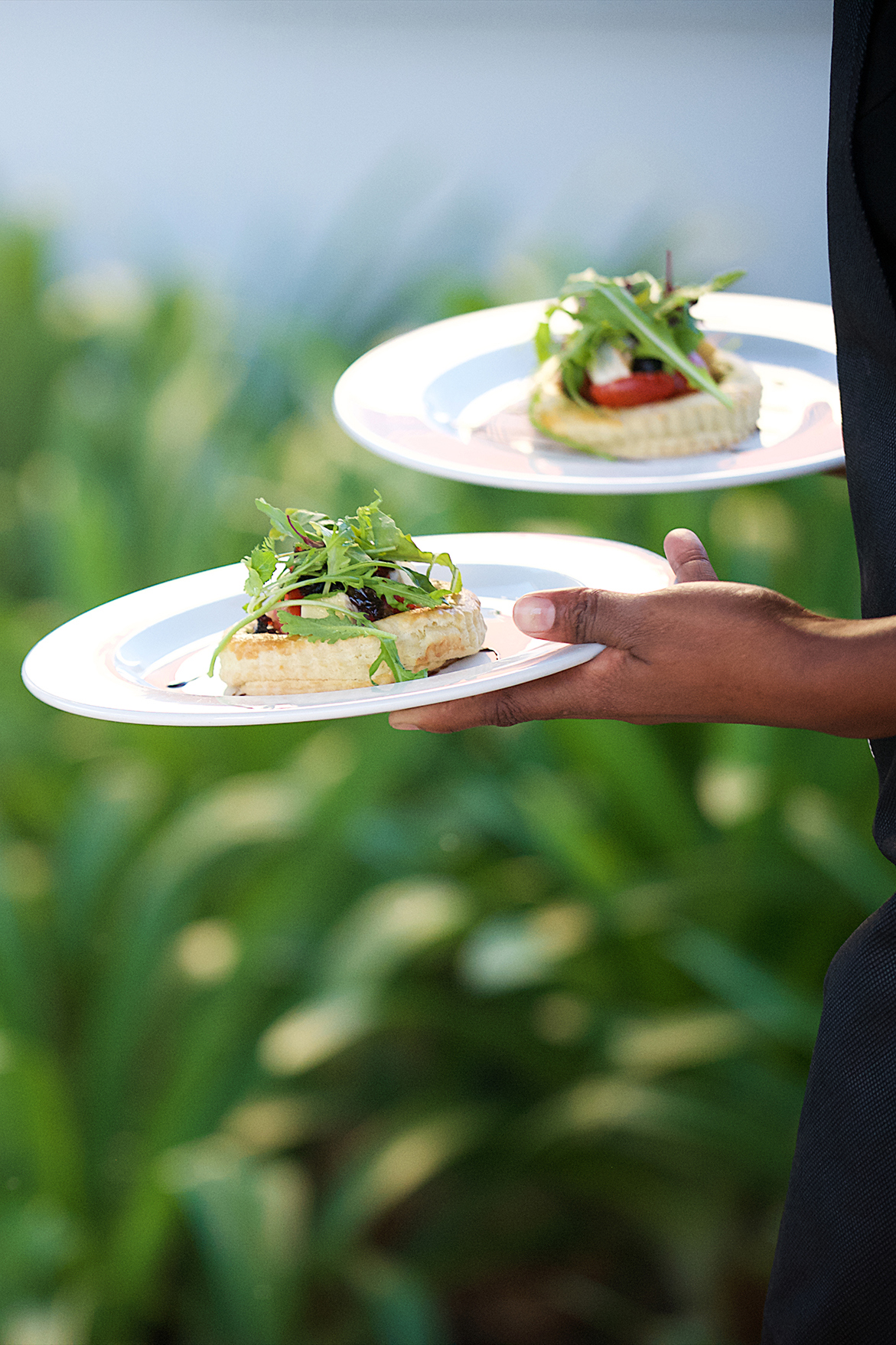 Waitor carrying two plates of food