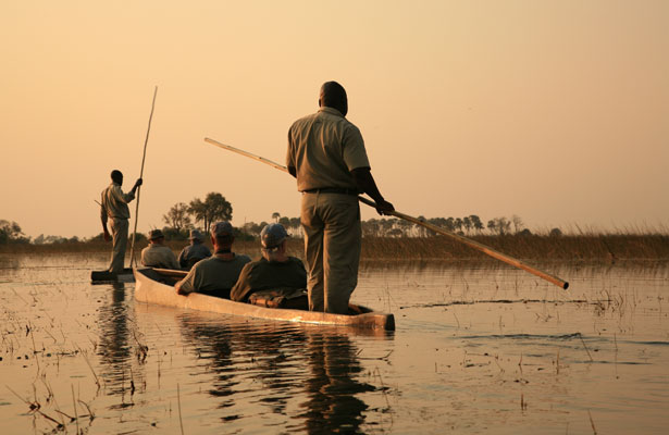 Two canoe boats with a Helmsman stood