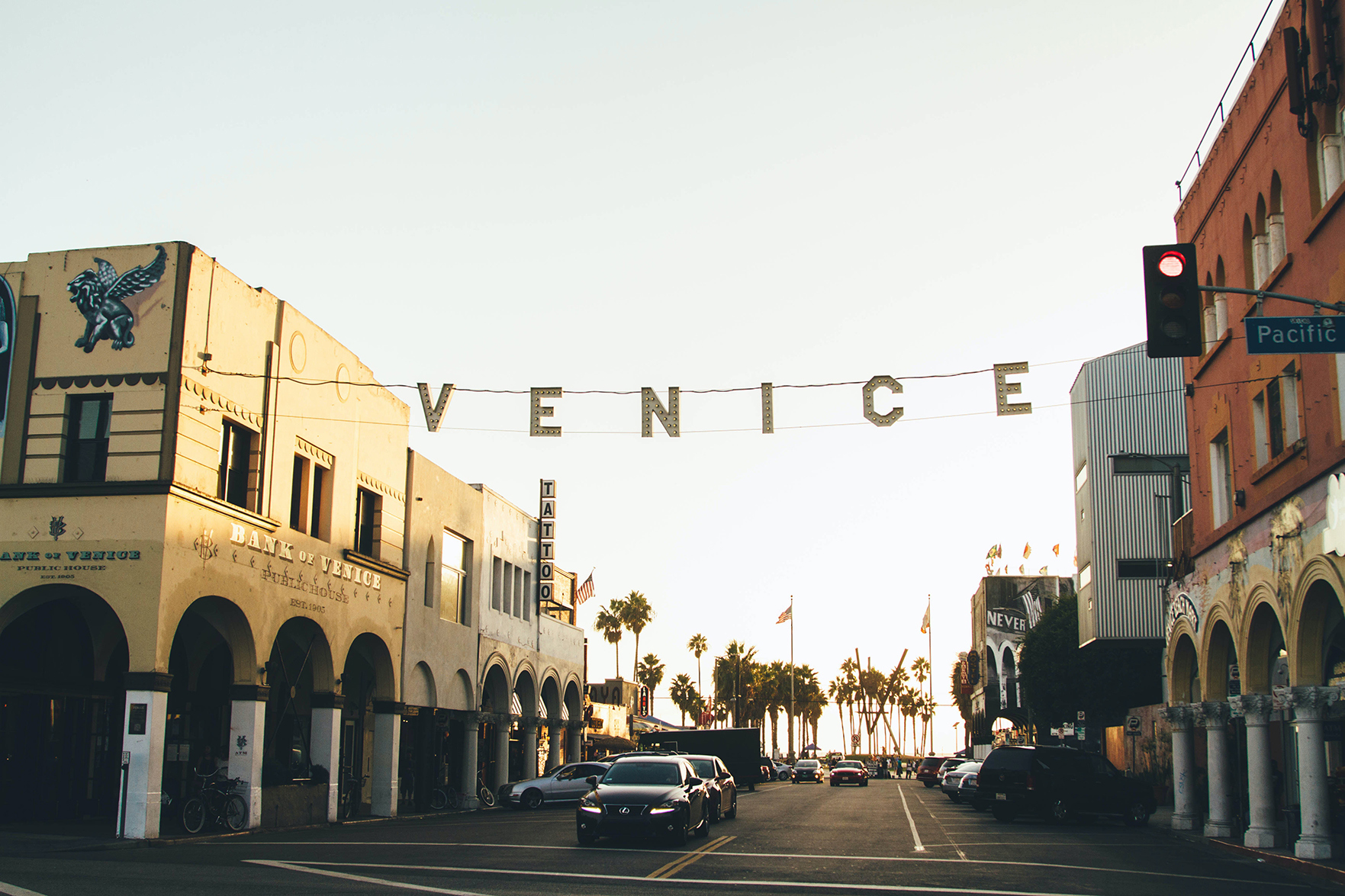 Iconic Venice Beach lights across road with black car 