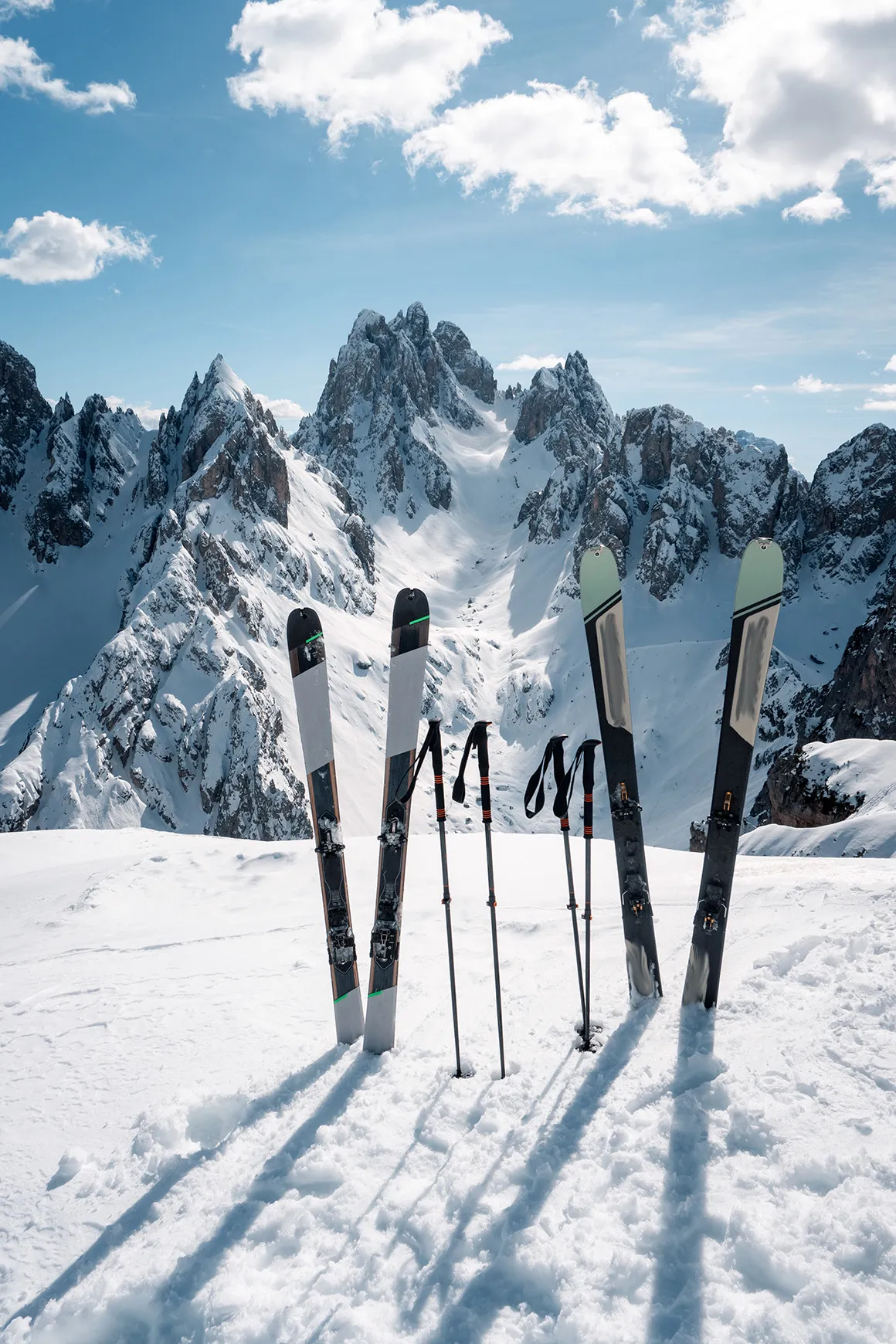 Two pairs of skis and ski poles stuck in the snow in the Dolomites 