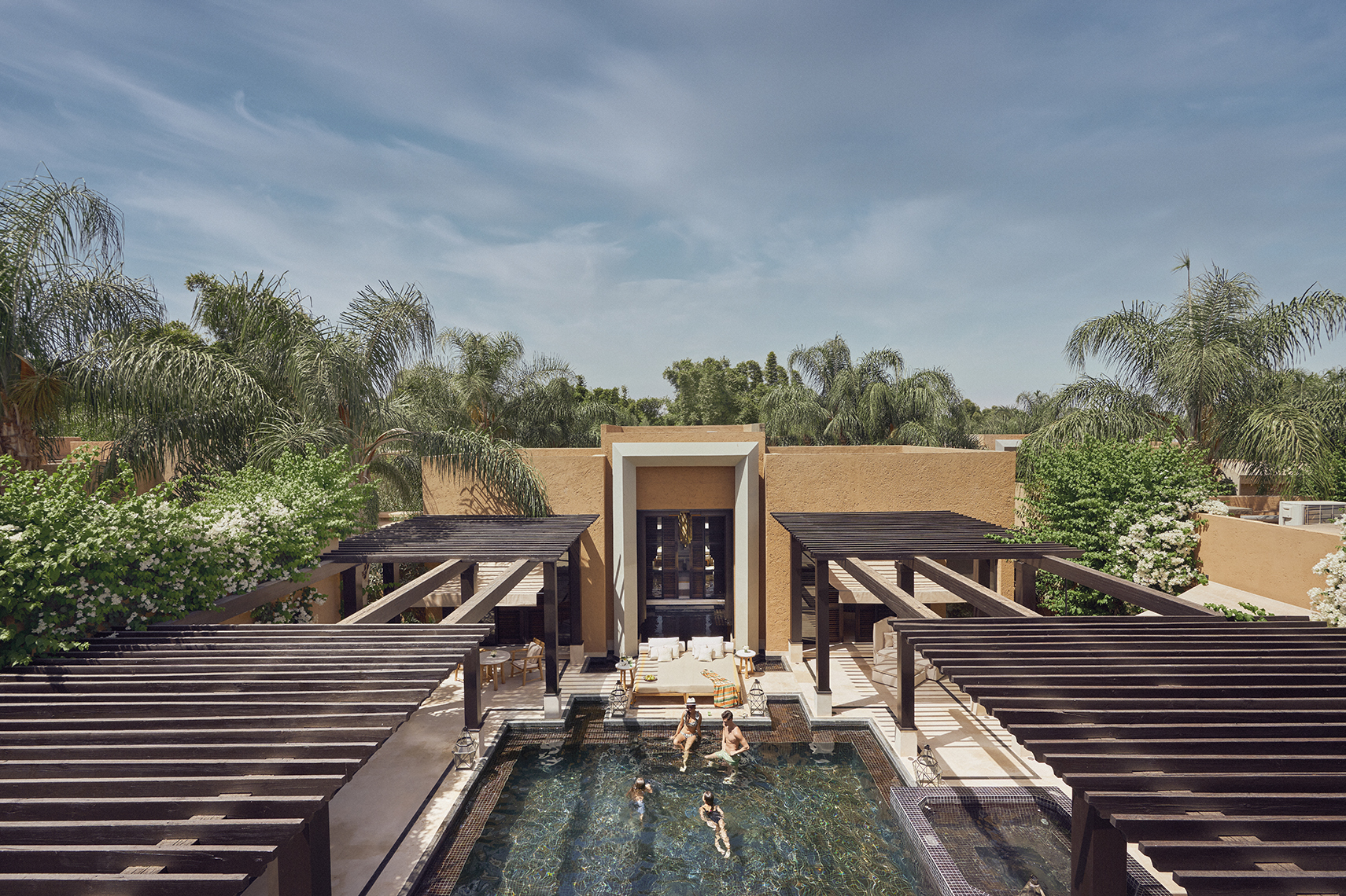 Africa, Morocco, Mandarin Oriental Marrakech, pool villa taken from above with family swimming in pool