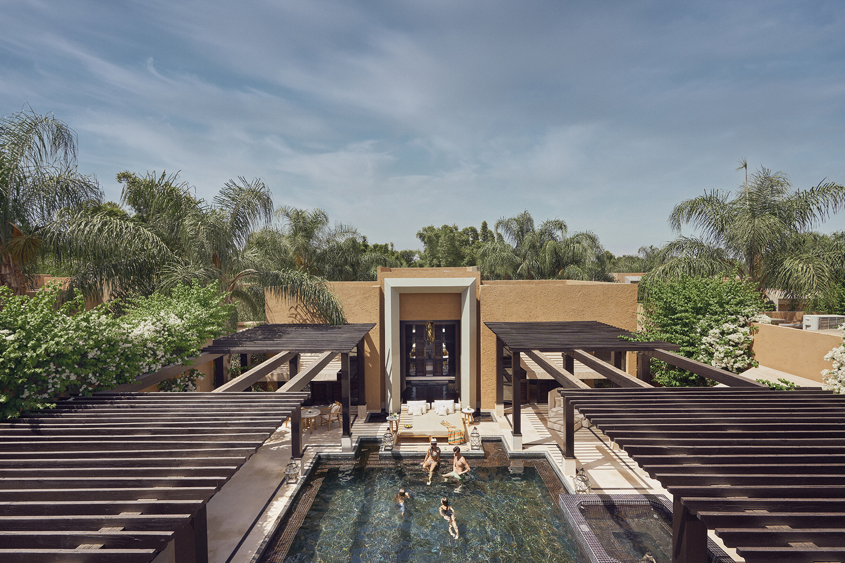 Africa, Morocco, Mandarin Oriental Marrakech, pool villa taken from above with family swimming in pool