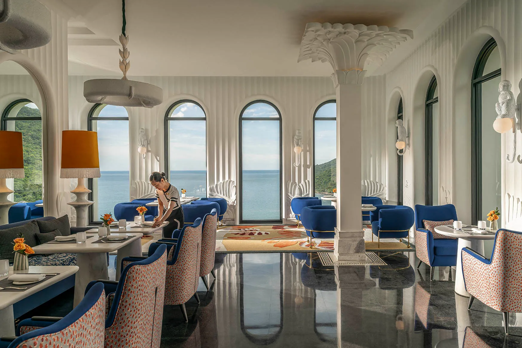Asia, Vietnam, InterContinental Danang, woman setting a table inside the Club Lounge 