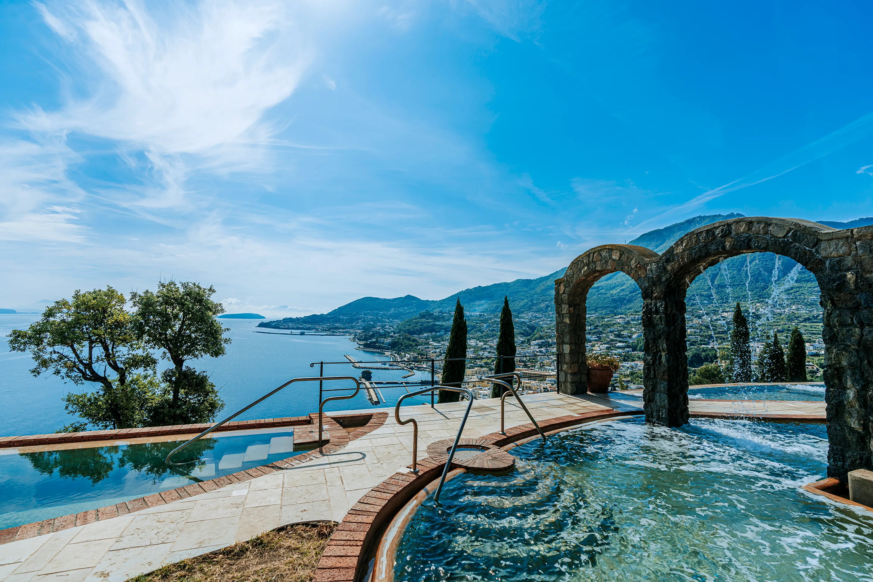 San Montano Resort on Ischia featuring a stunning infinity pool with panoramic views of the sea and mountains.