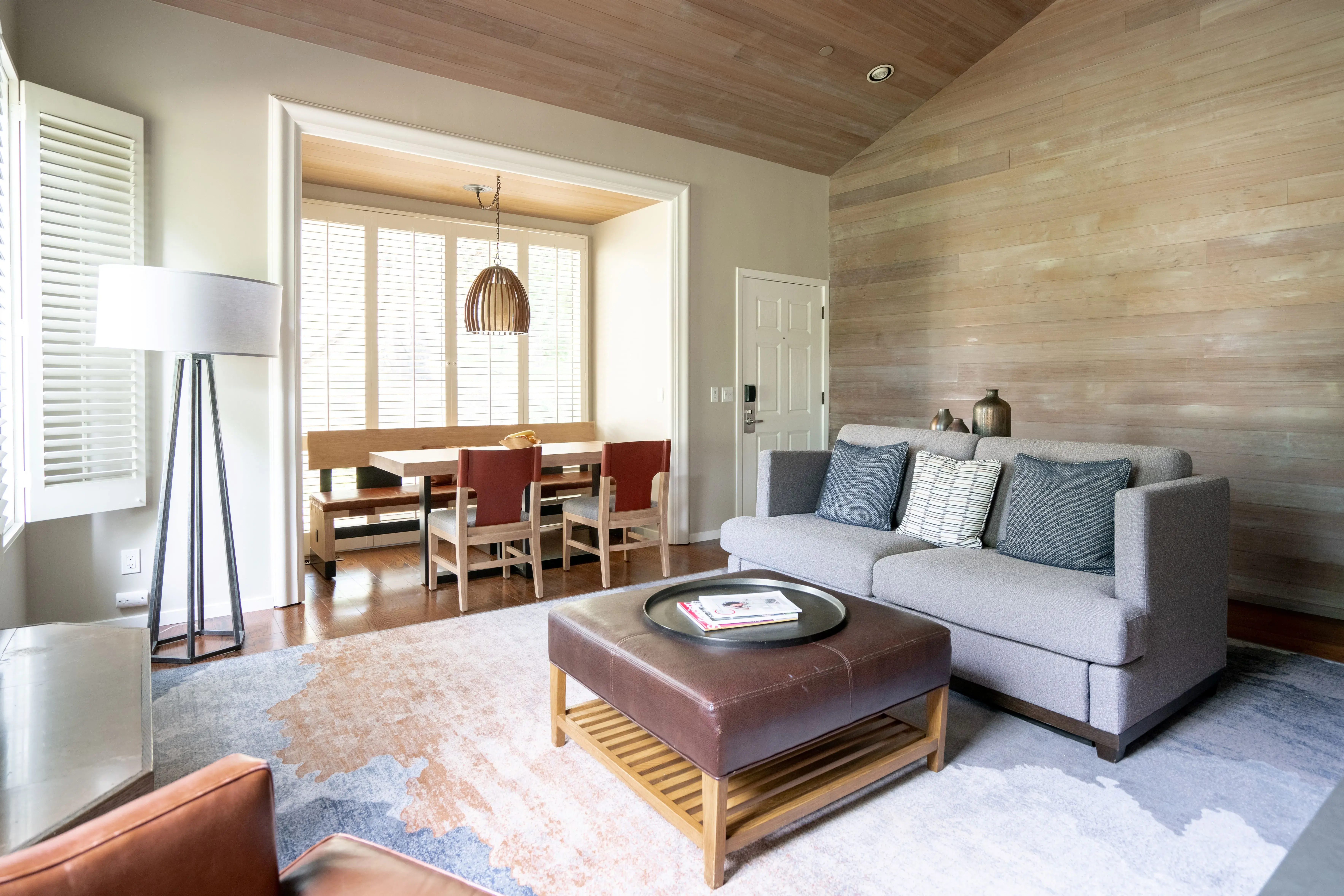 Mondern ranch style living room in a Ranch Suite at Carmel Valley Ranch in California featuring a sofa, coffee table and dining area