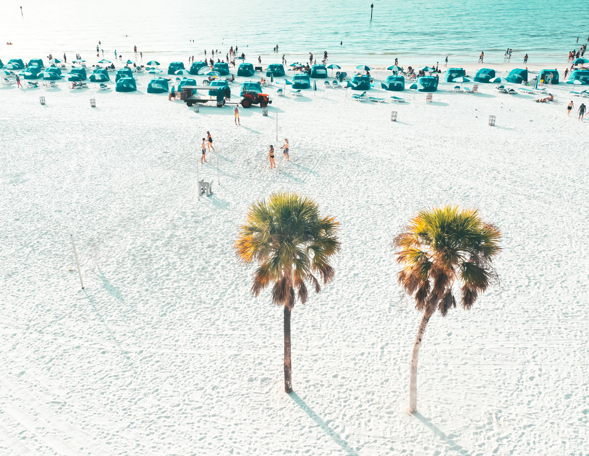 People playing volleyball on a sandy beach