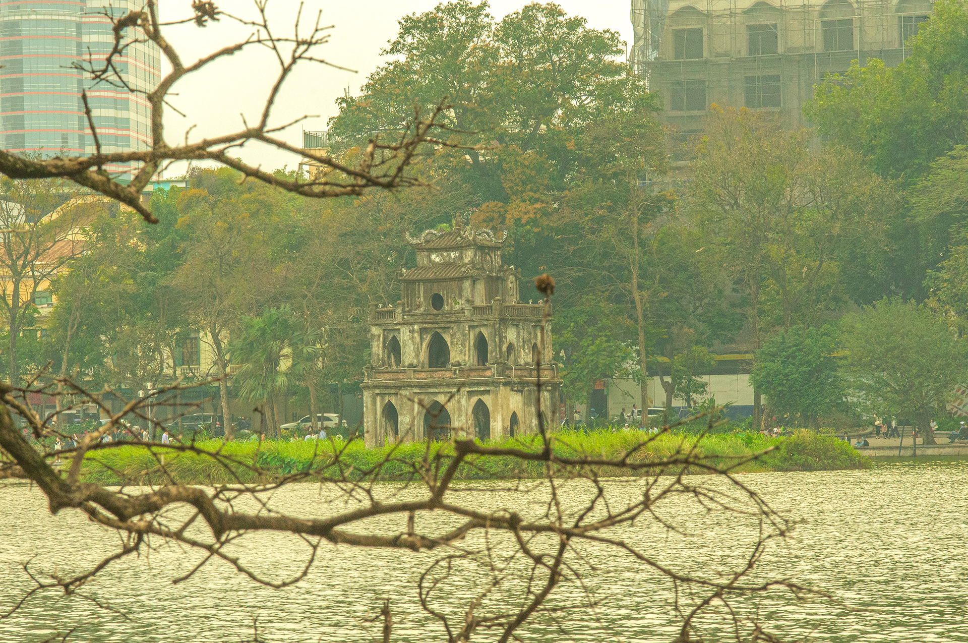 A old concrete temple building on a mound on Hoàn Kiếm Lake