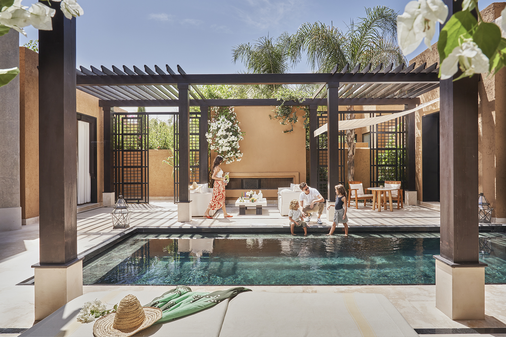 Africa, Morocco, Mandarin Oriental Marrakech, family sat around pool villa pool