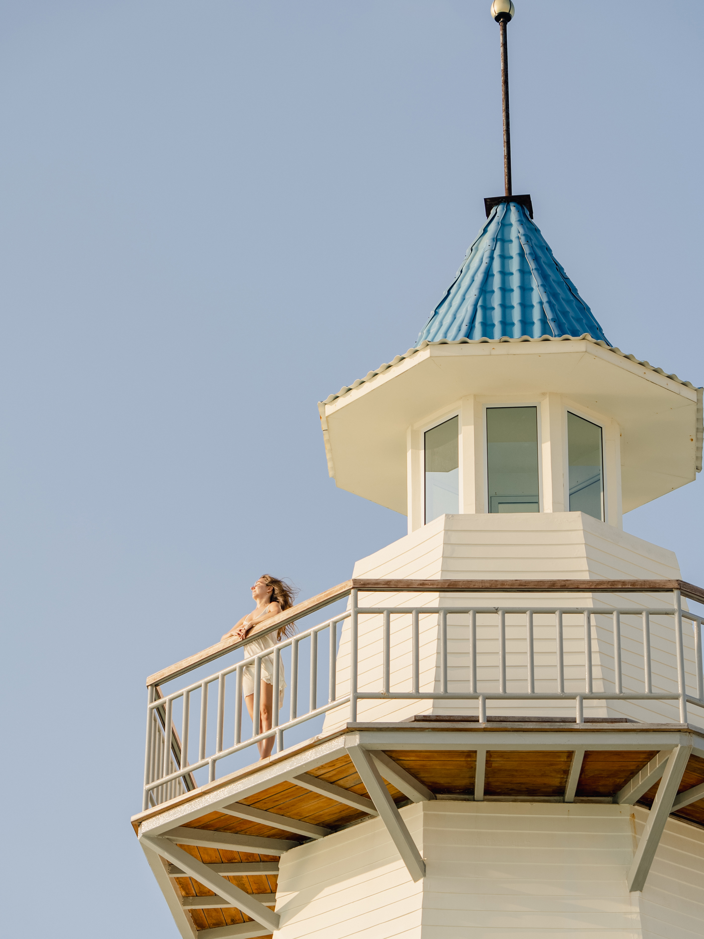 Woman enjoying the view from The Lighthouse Restaurant balcony at InterContinental Maldives.