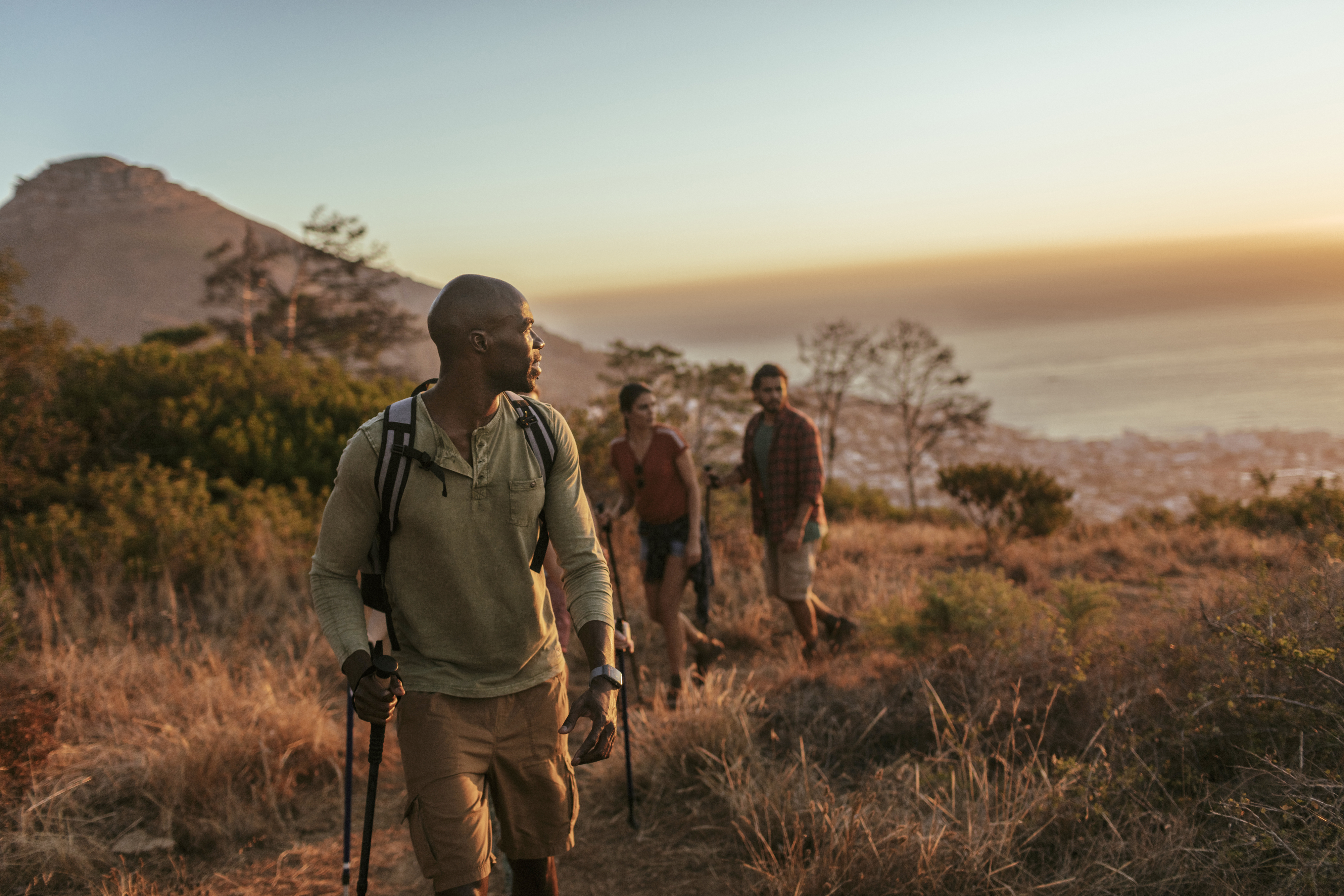 People walking as the sun sets