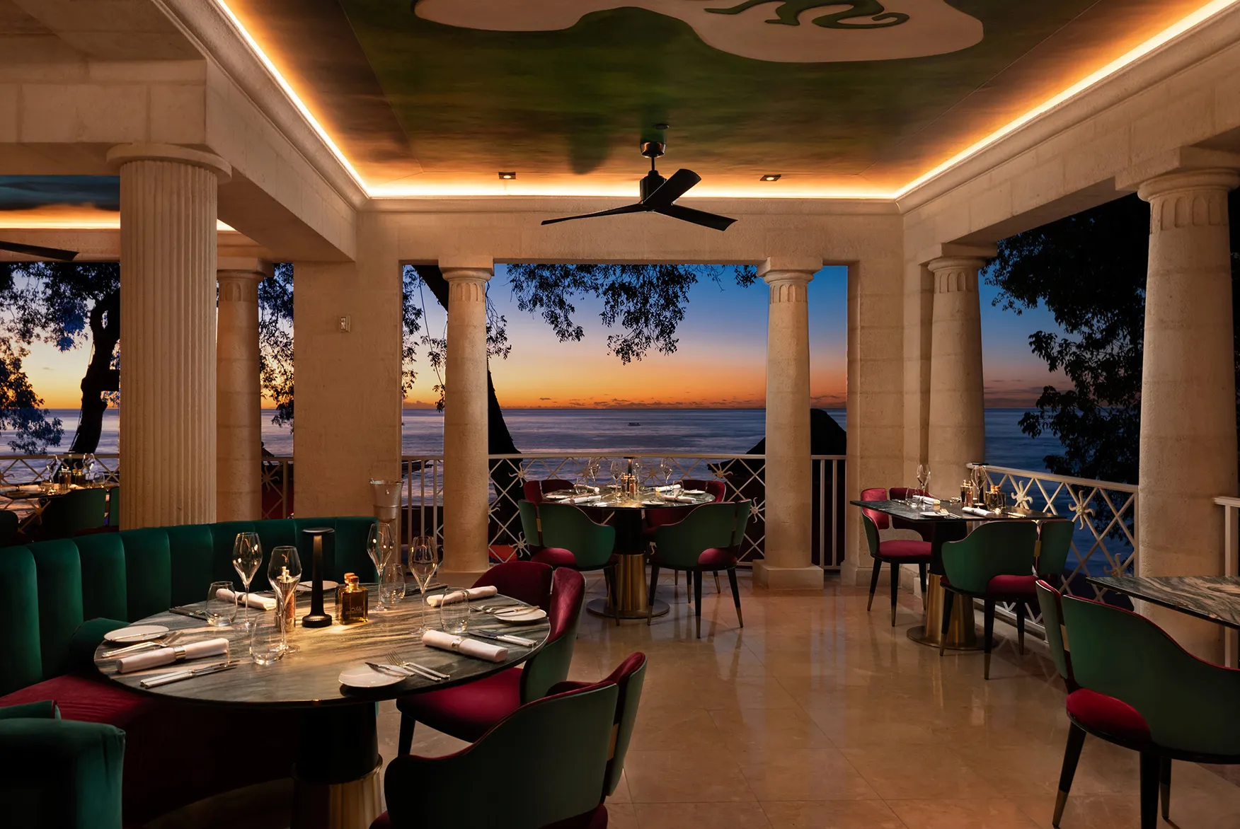 Caribbean, Barbados, Sandy Lane, tables set for dinner at The Monkey Club with a sunset view