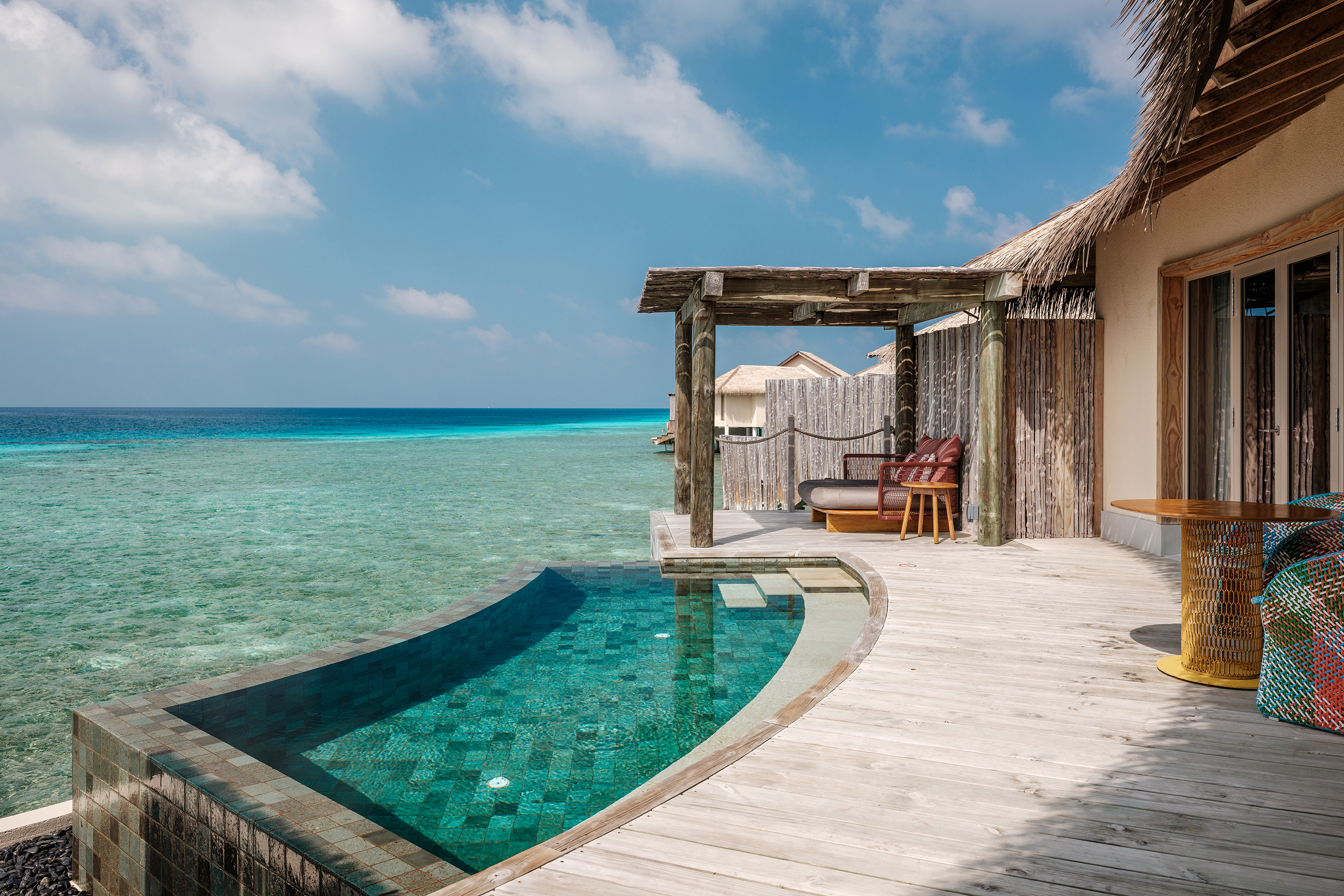 Luxurious overwater villa with private infinity pool overlooking the turquoise ocean at InterContinental Maldives.