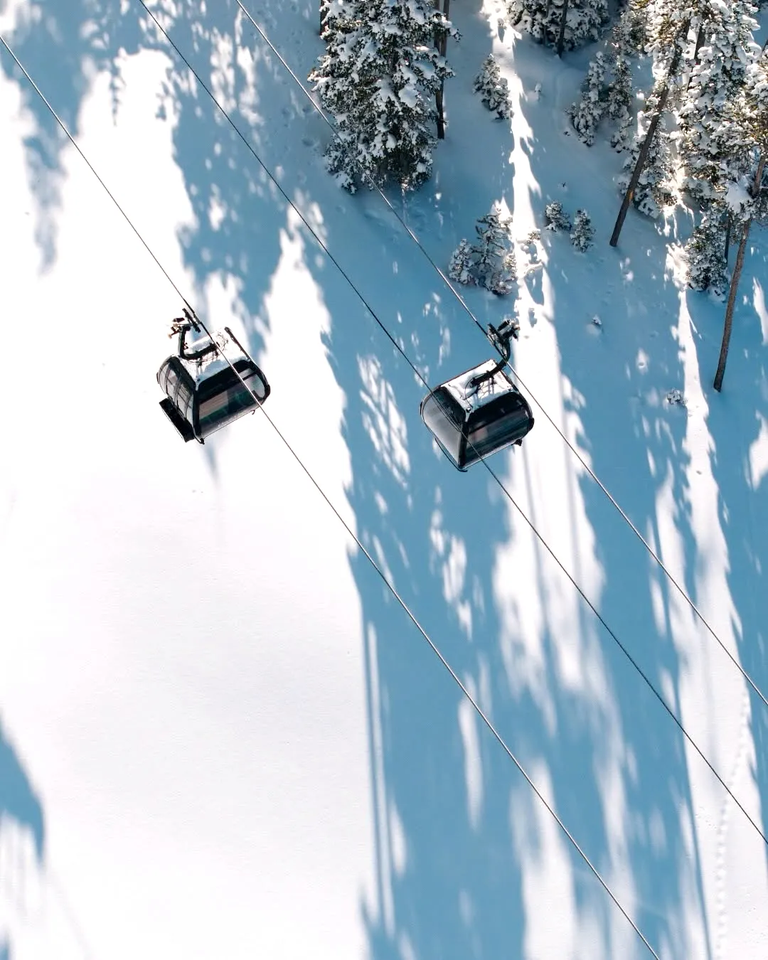 Two gondolas above the snow at One&Only Moonlight Basin, Montana, USA