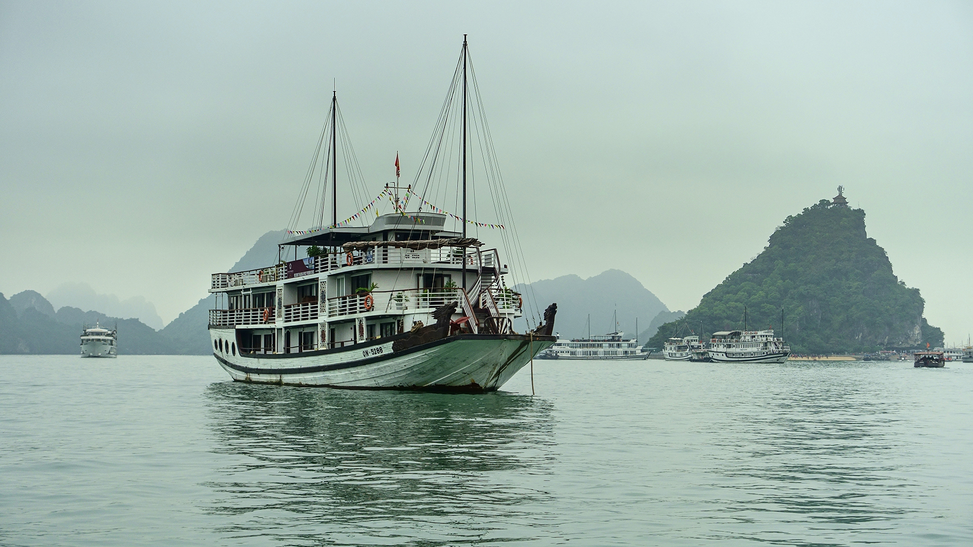Ha Long Bay white small cruise boat on the water