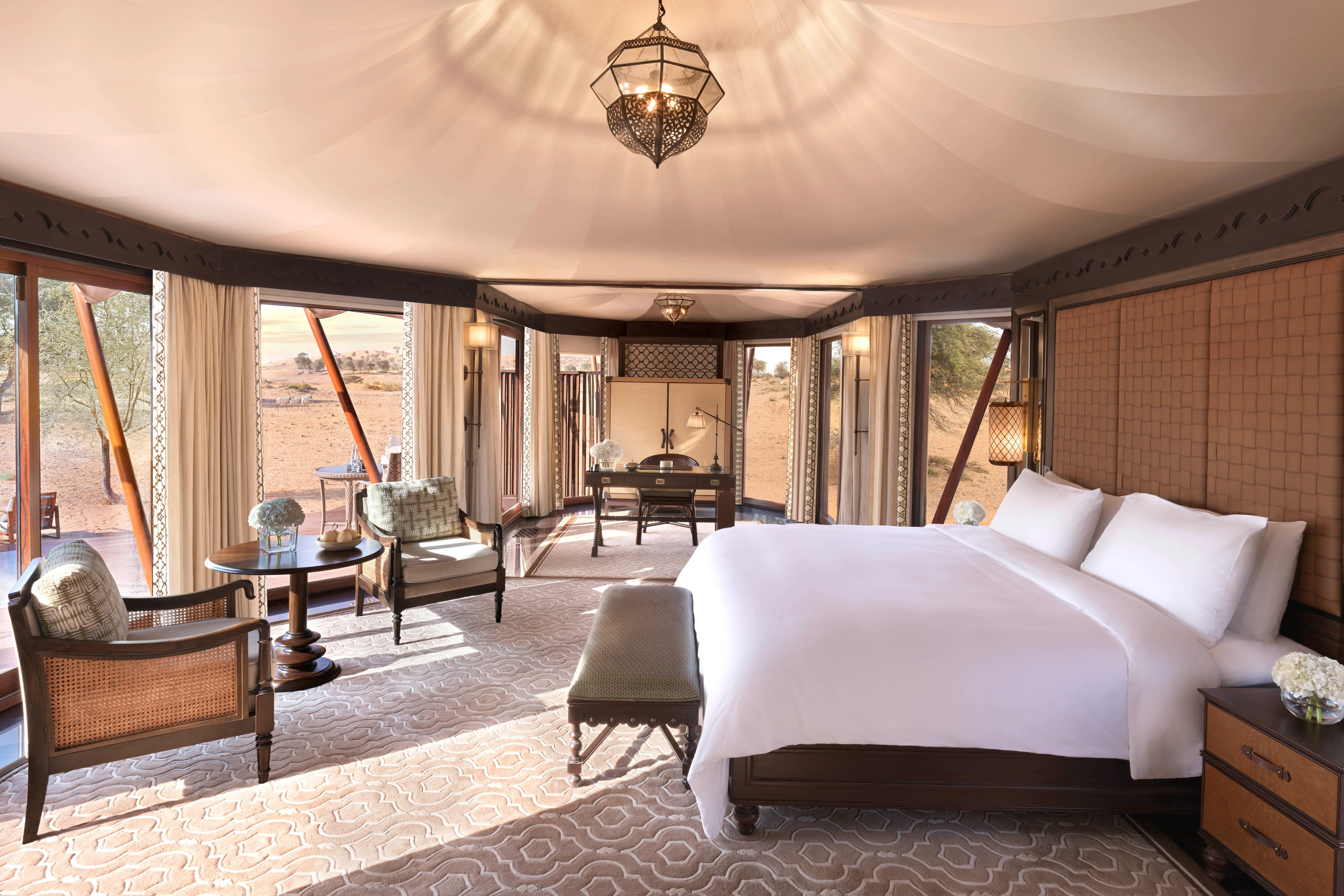 Elegant desert-view bedroom with king bed and traditional décor at The Ritz-Carlton Ras Al Khaimah, Al Wadi Desert.
