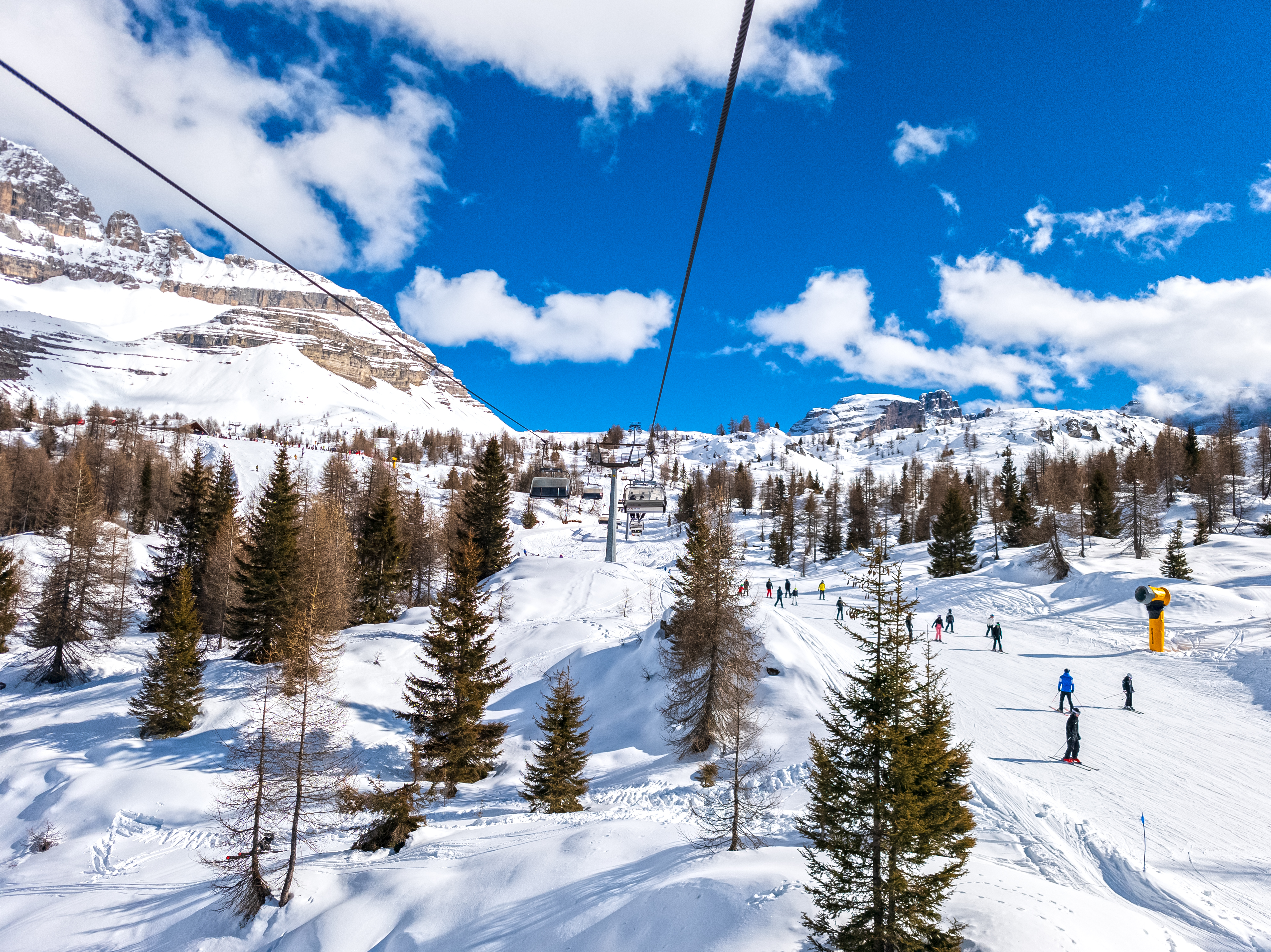 Skiiers in the in Madonna di Campiglio landscape, Dolomites, Italy