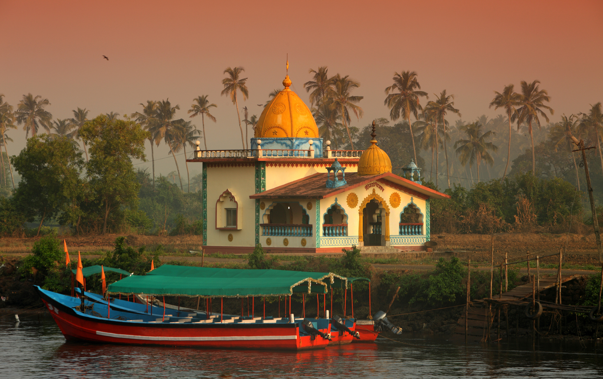 a building with a yellow dome next to a boat