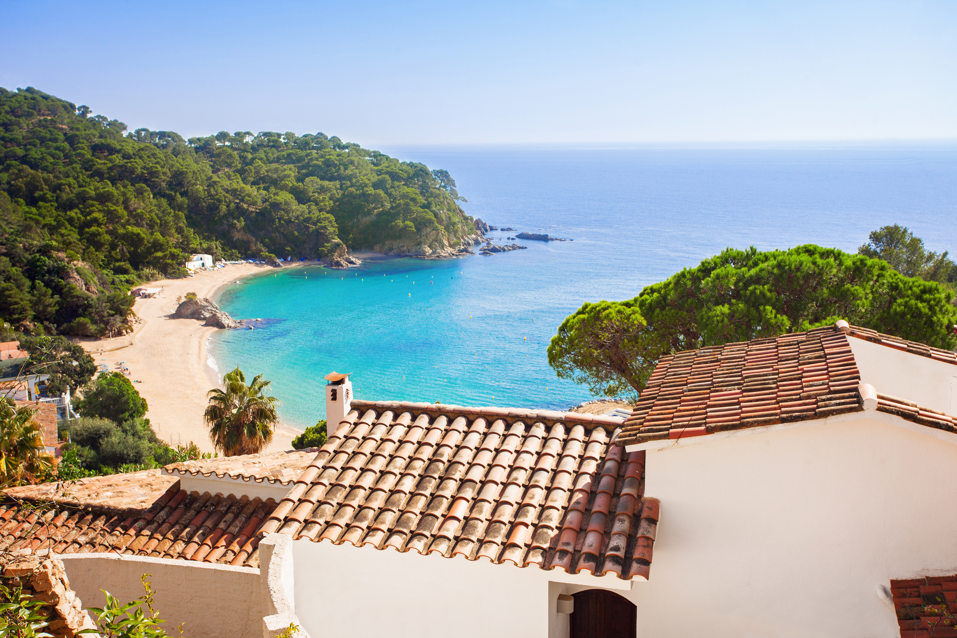 View over roofs at a sandy beach cove