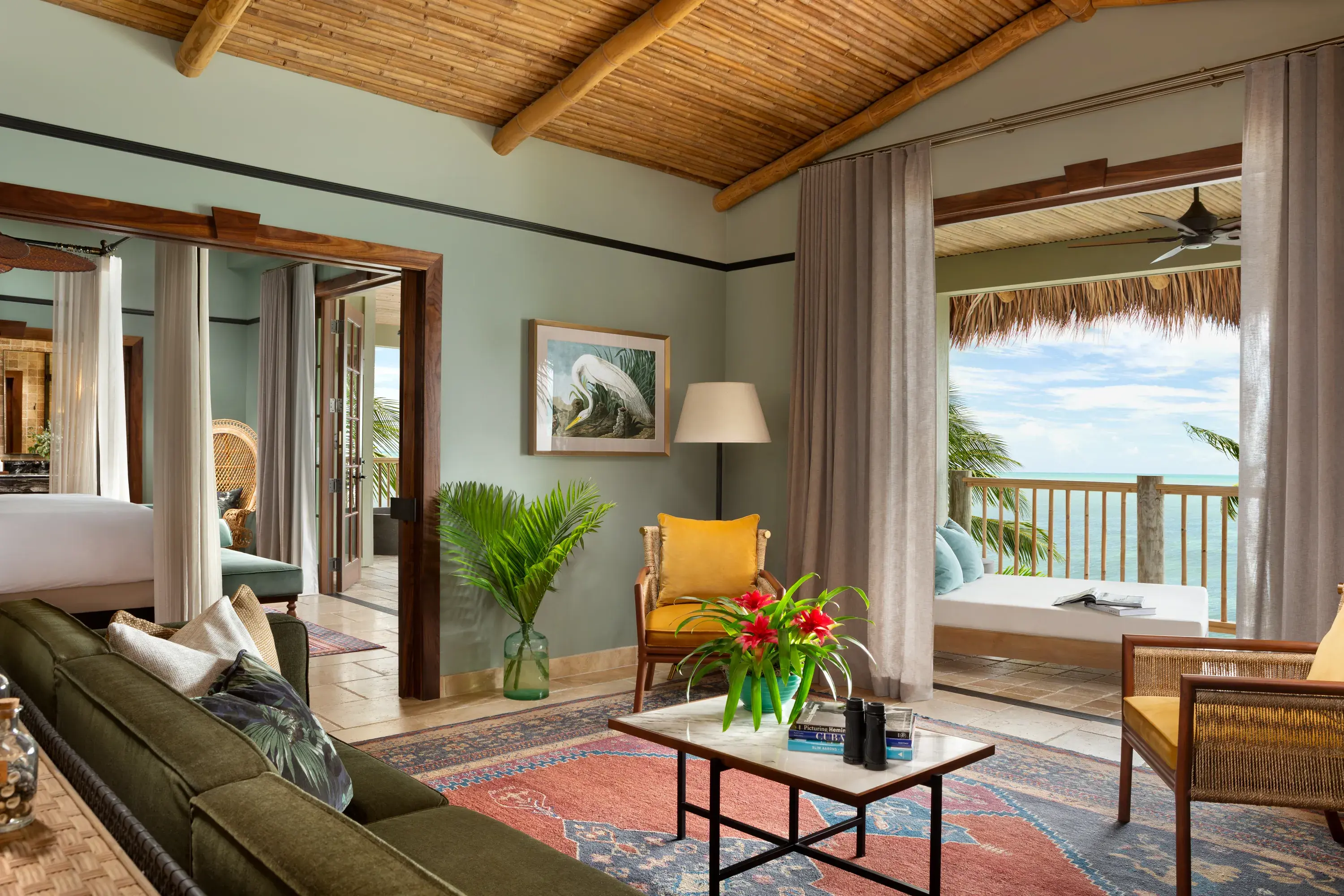 Luxury ocean-view Premier Suite at Little Palm Island Resort in Florida featuring bamboo ceiling, elegant living area, and private terrace.