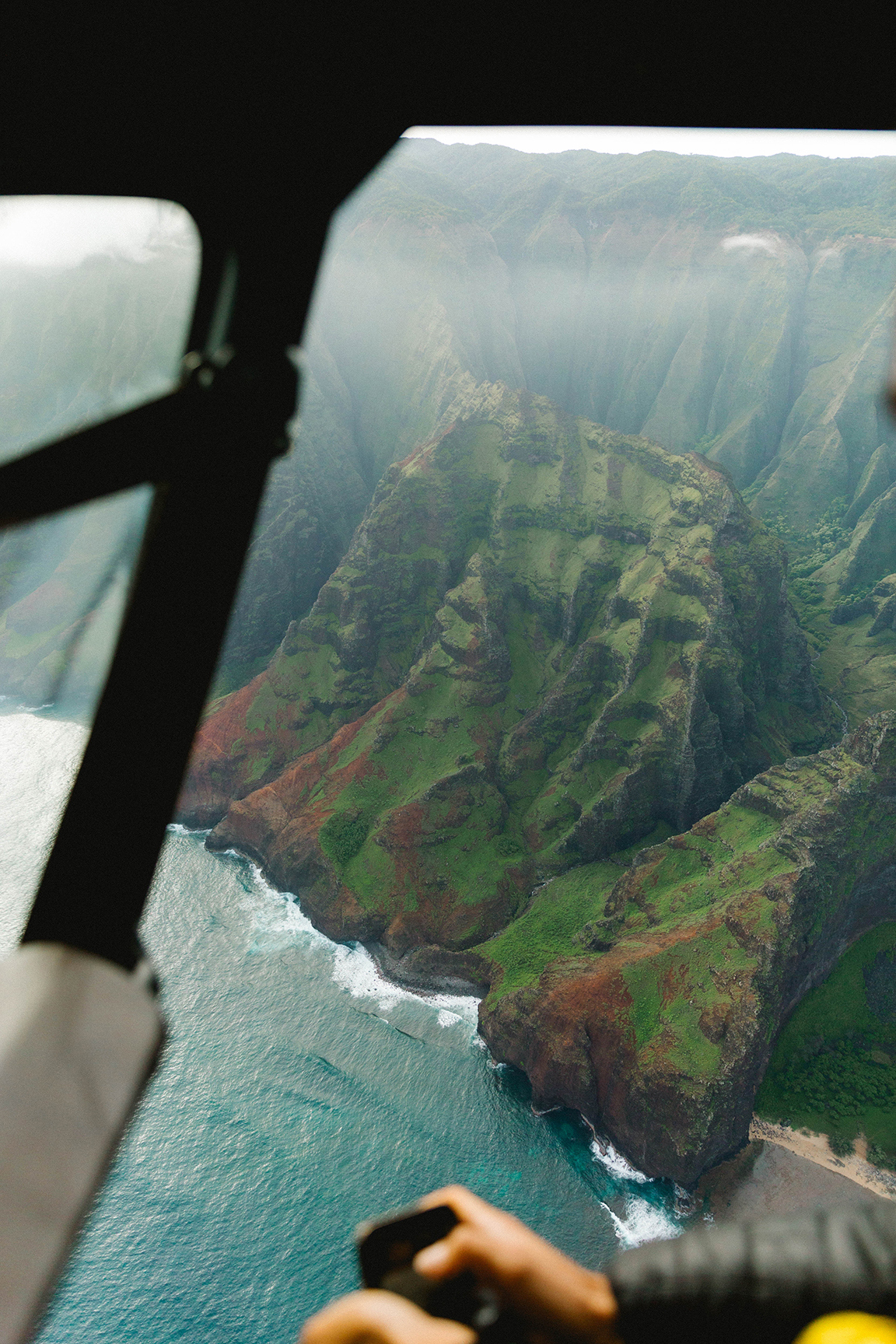 View from helicopter window down to mountains in Hawaii
