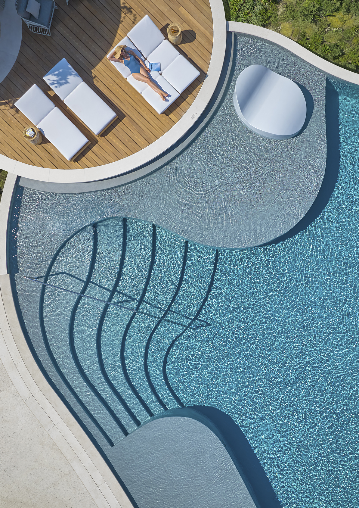 Europe, Greece, Mandarin Oriental Costa Navarino, aerial image of woman sunbathing in Ormos Royal Cabana