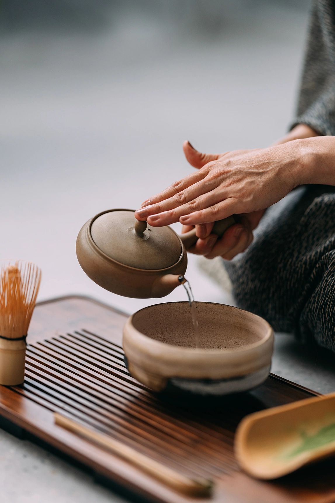 Woman making traditional Japanese tea 