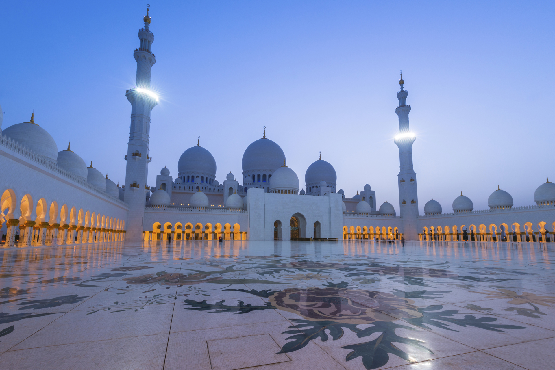 a large mosque building with domes and towers