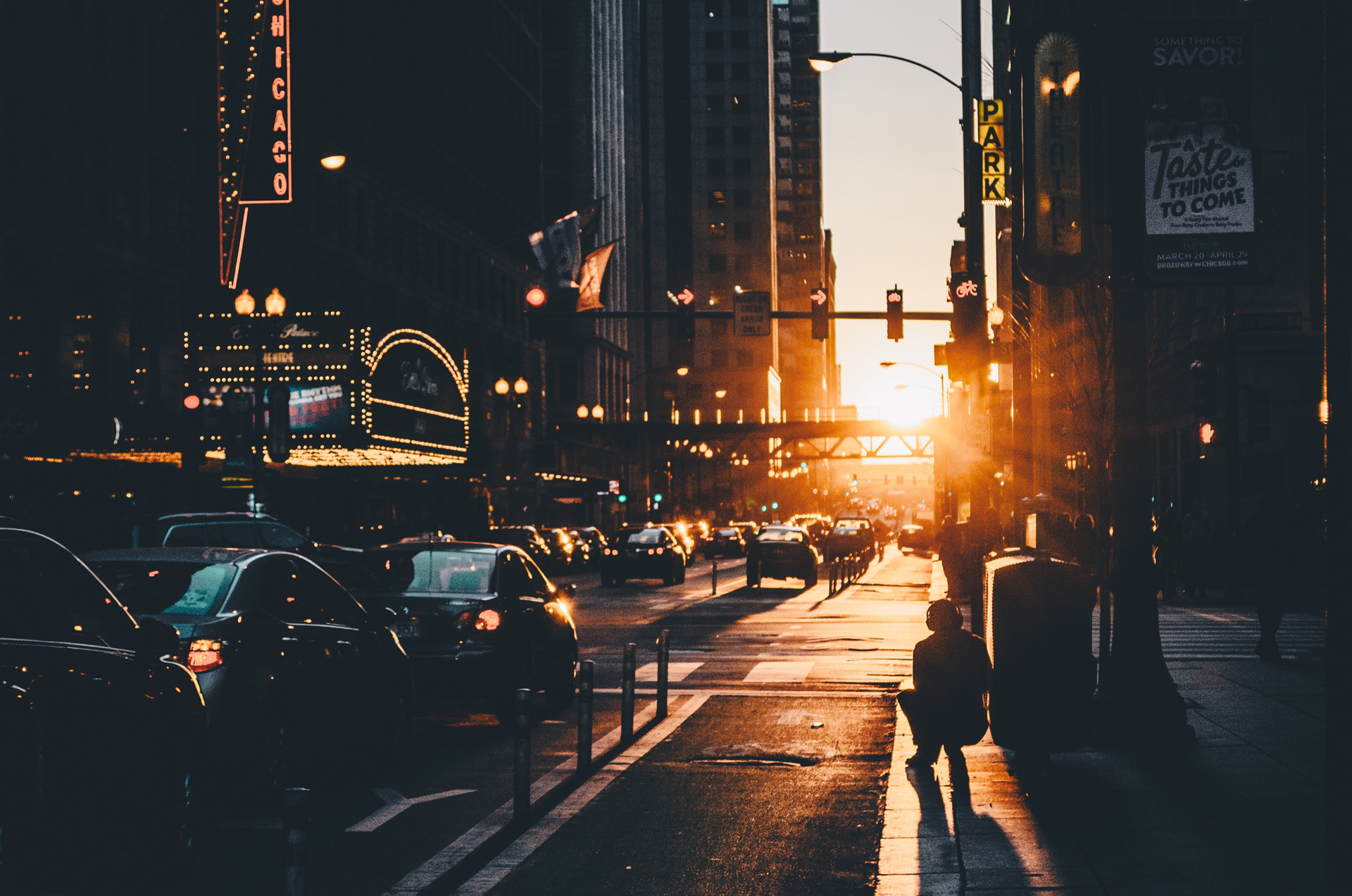 Cars on a busy city road as the sun sets