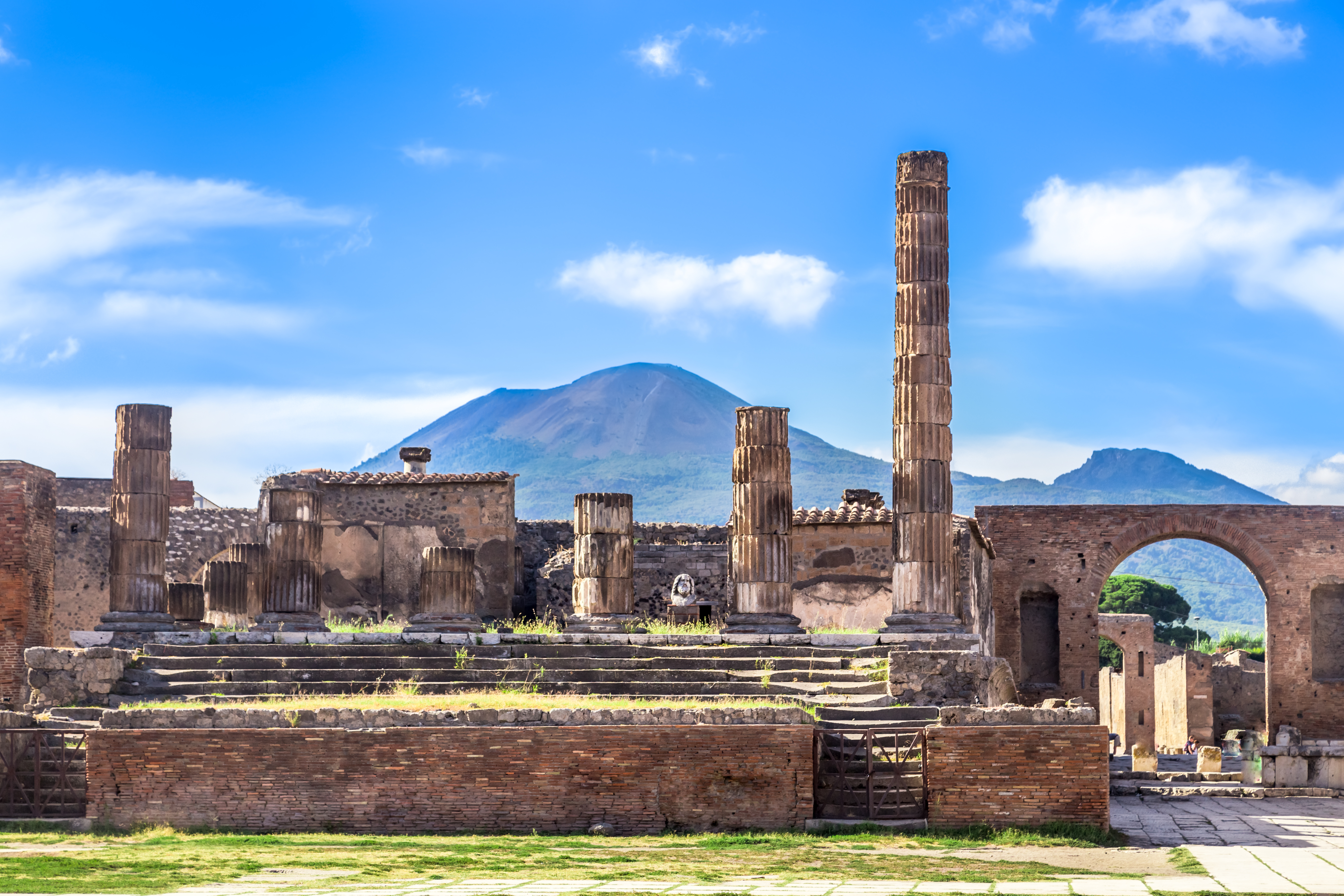 ruins of the antique Temple of Apollo IN Pompeii with views of Mount Vesuvius 