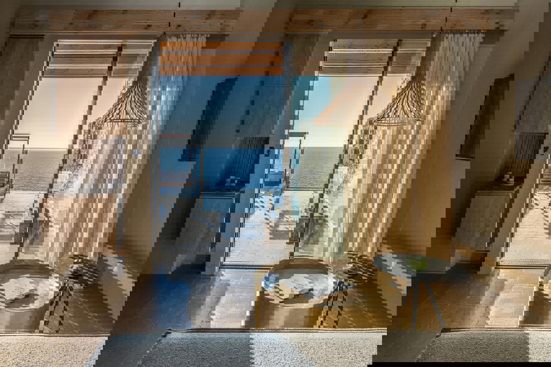 Lounge of a suite at Acro Wellness looking out to private pool and cabana