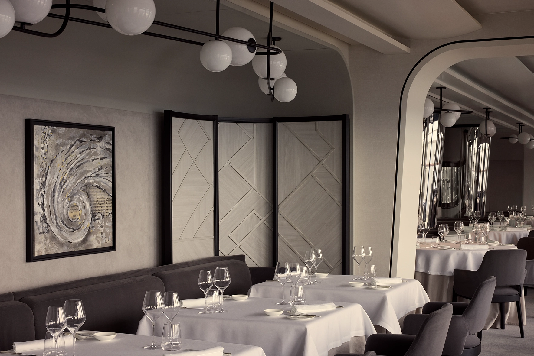 The tables set for dinner service in Anthology Restaurant onboard the Explora I cruise ship