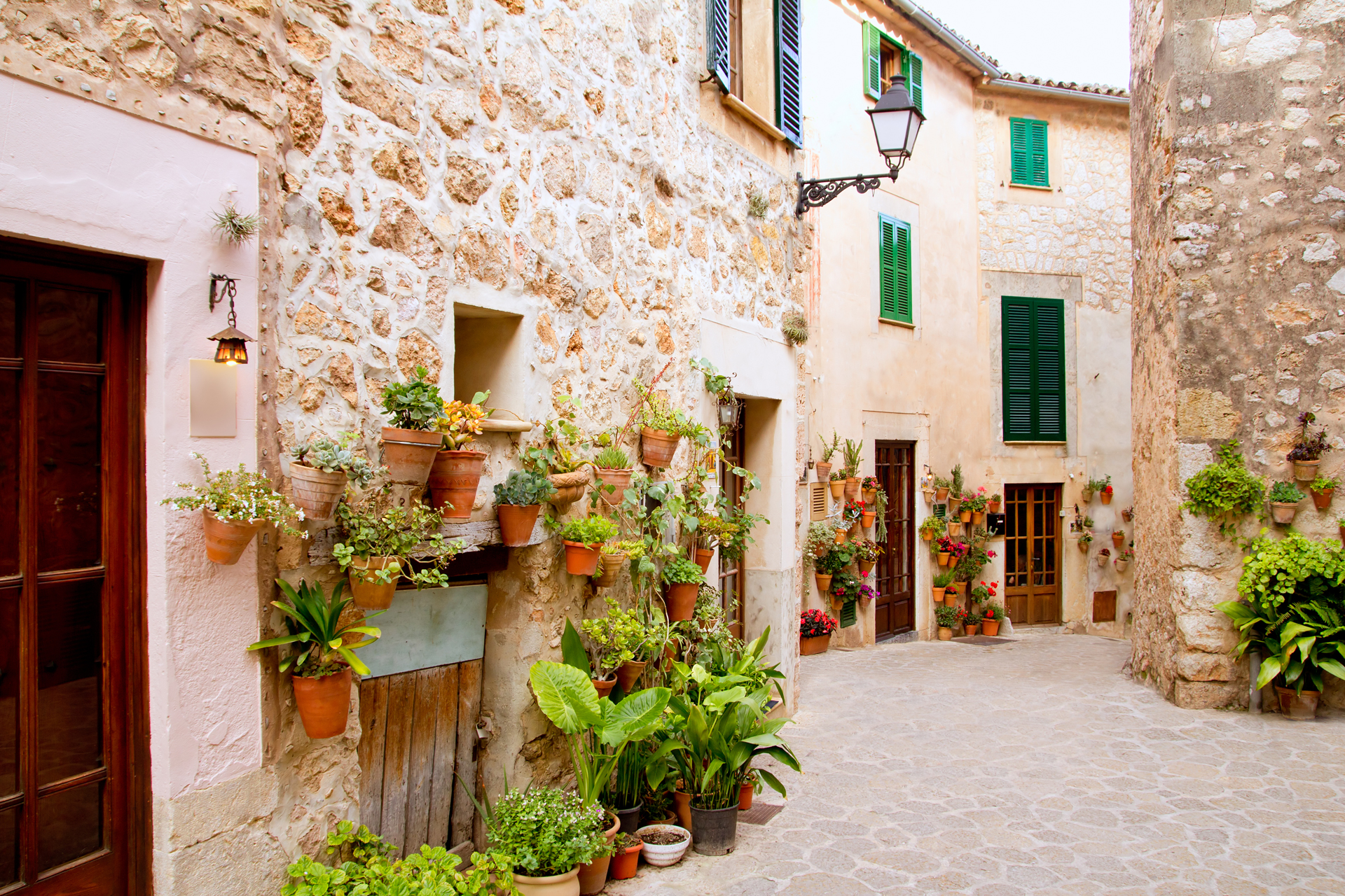 Facade with stone houses and flower pots