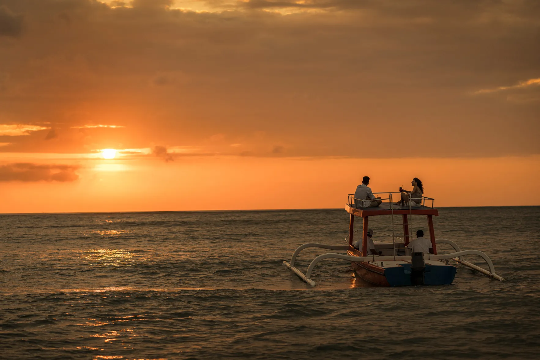 Two people on a sunset cruise at Four Seasons Resorts Bali at Jimbarana Bay, Indonesia 