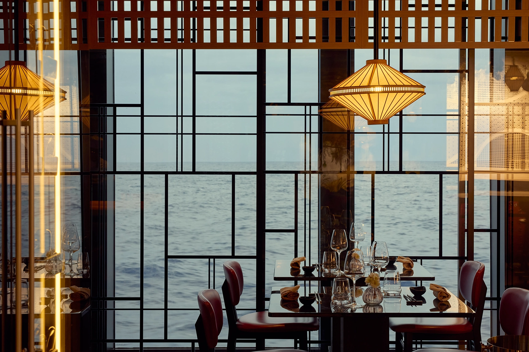 Dining tables for 2 by the window at Sakura Restaurant onboard Explora I cruise ship