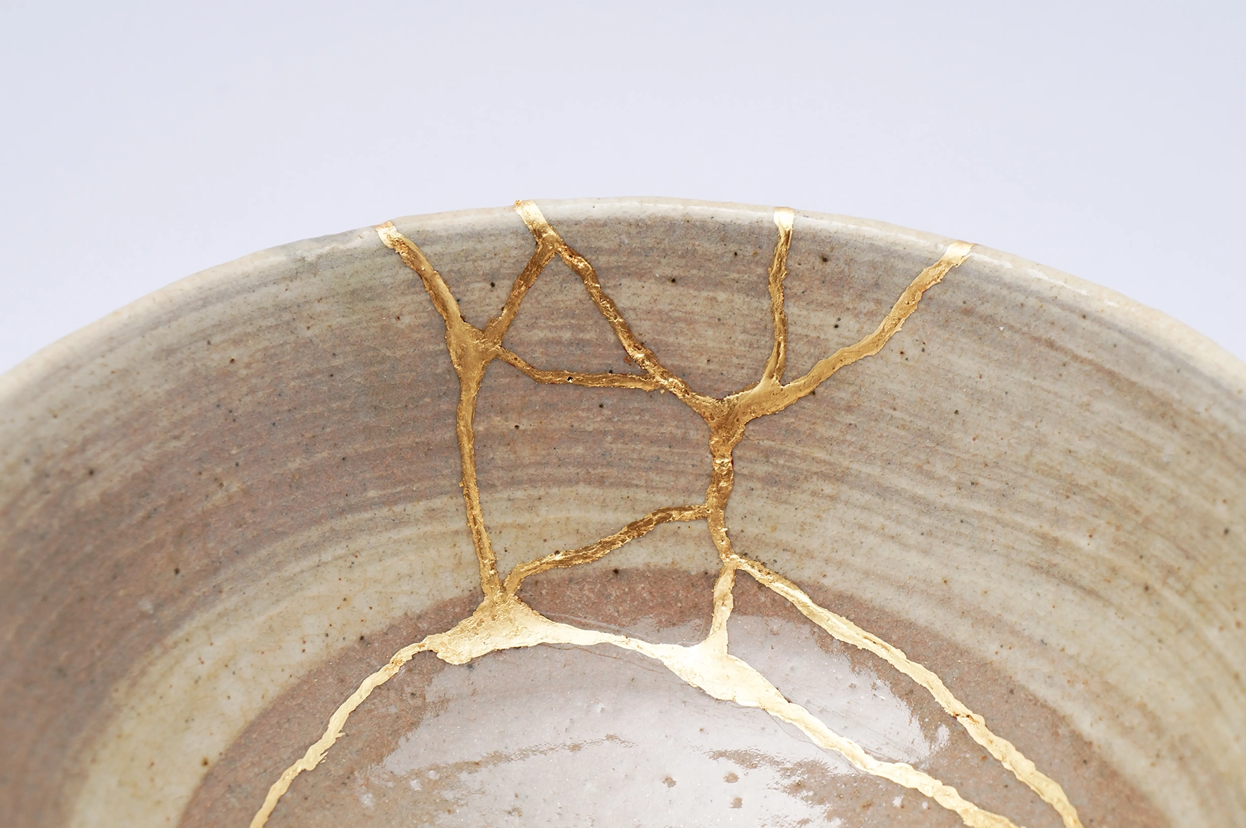 A cermaic pot repaired with gold in the traditional Kintsugi style 