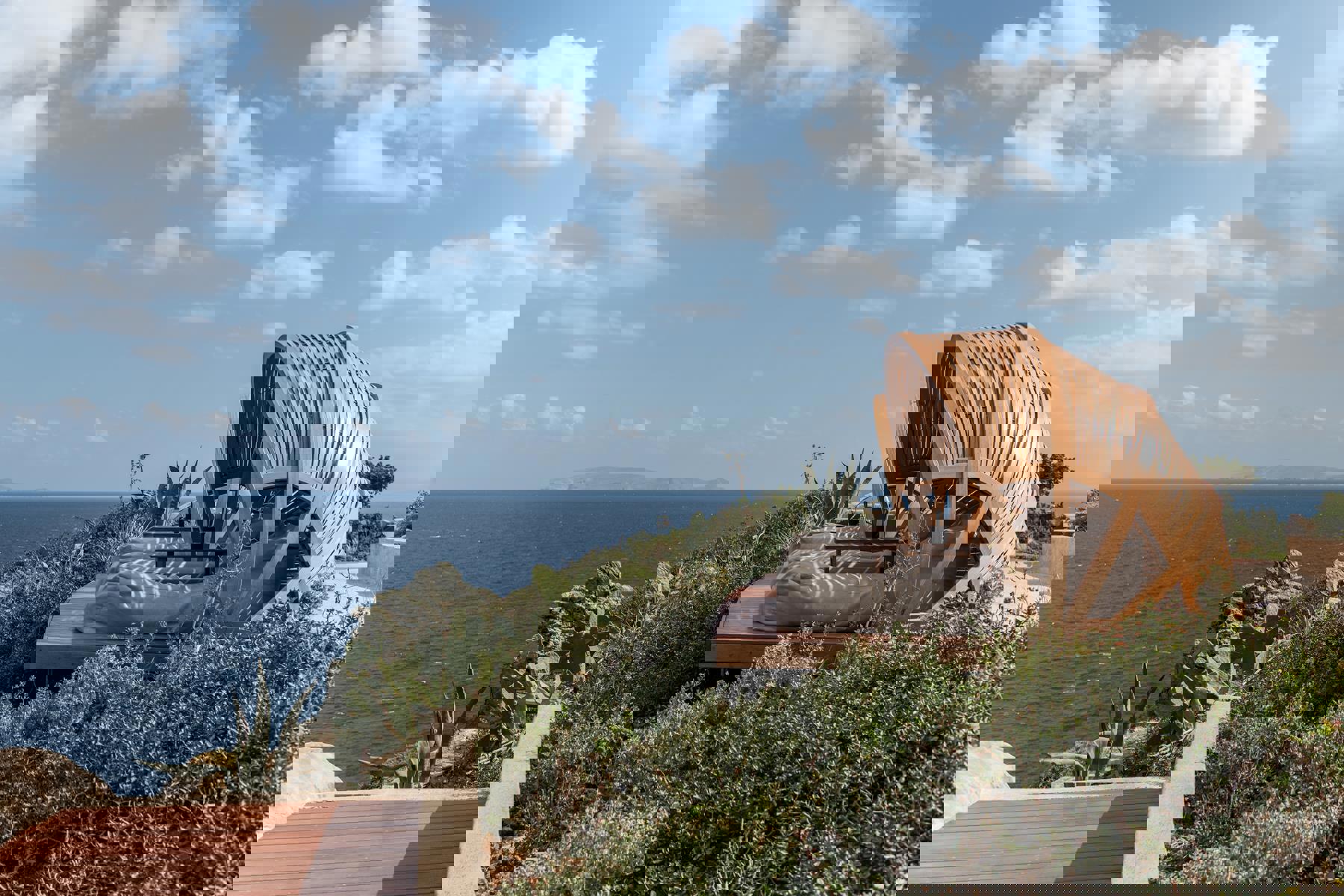 Cocoon loungers overlooking the ocean at Acro Wellness