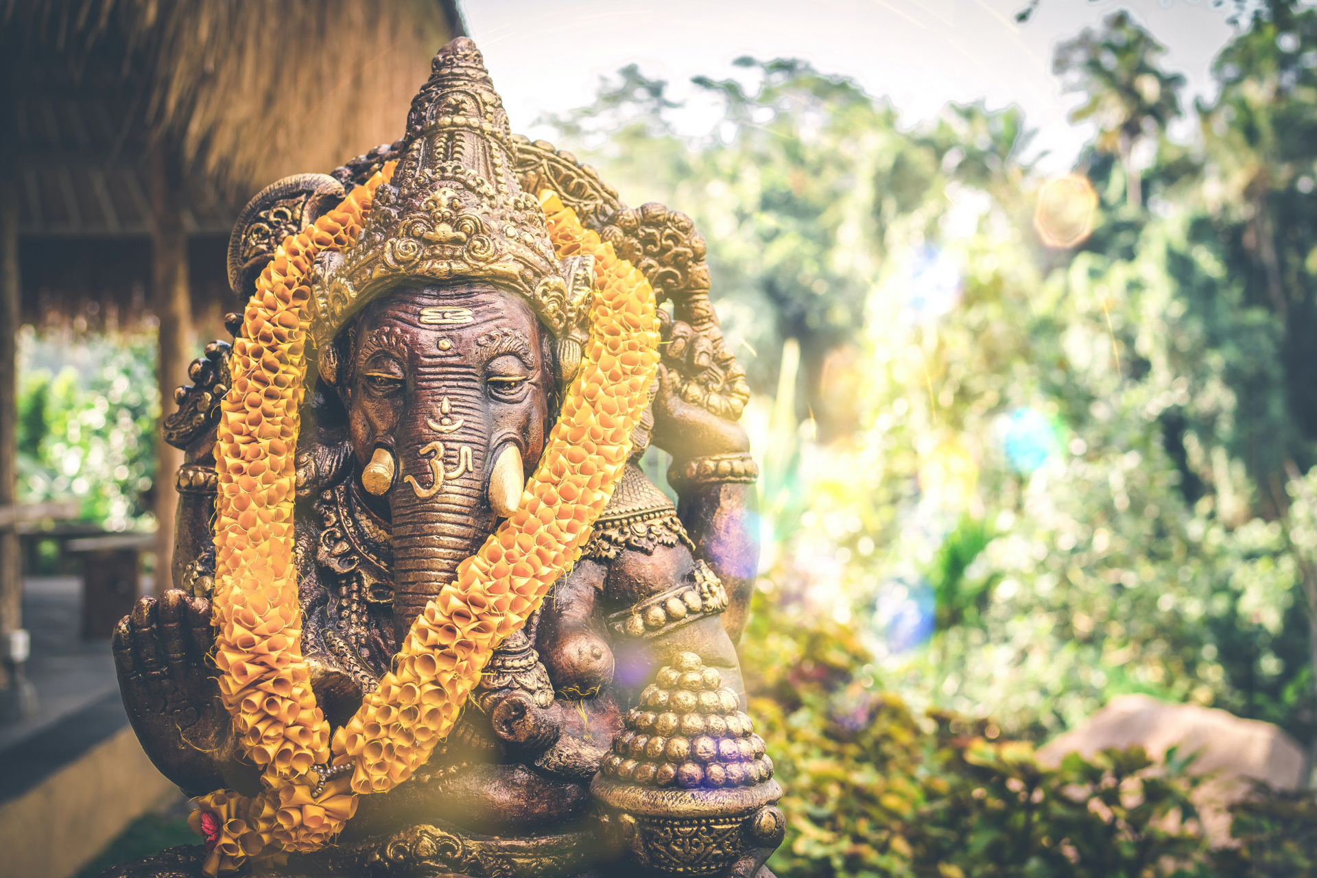 a statue of an elephant with a garland around it
