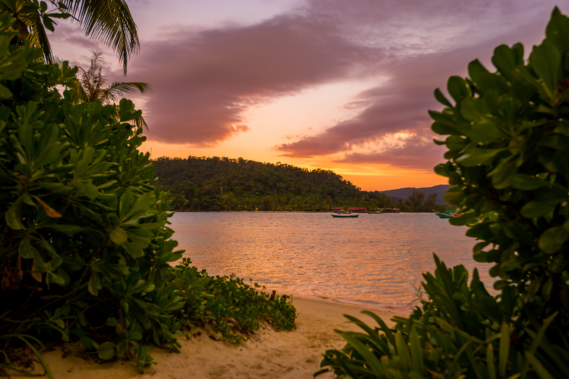 View from the beach of the sea and hills during sunset
