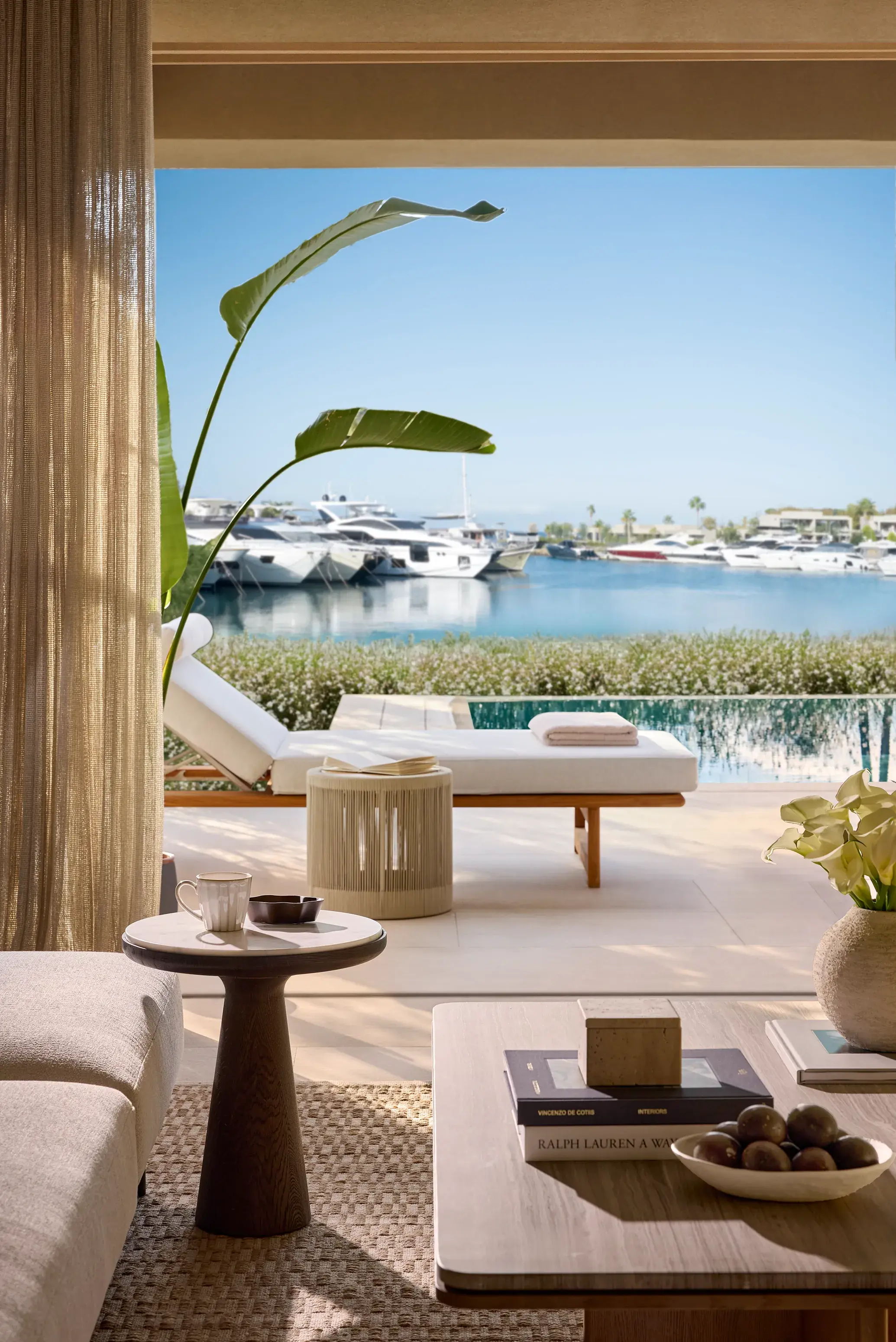 Luxury three bedroom residence at Sani Asterias in Halkidiki with private terrace, sun loungers and serene marina views over the Aegean.