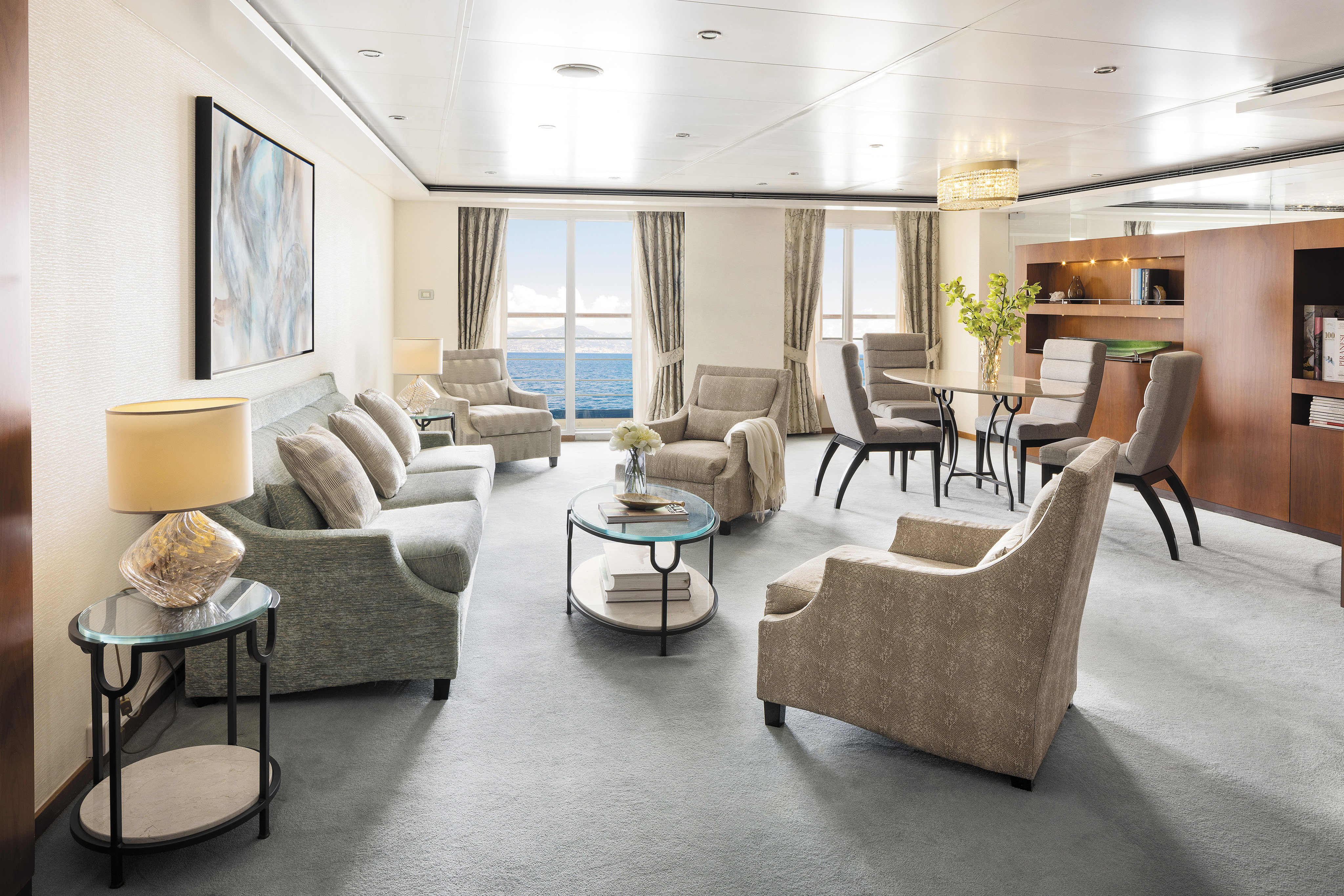 Lavish suite aboard a Seven Seas Voyager with plush furniture in muted tones