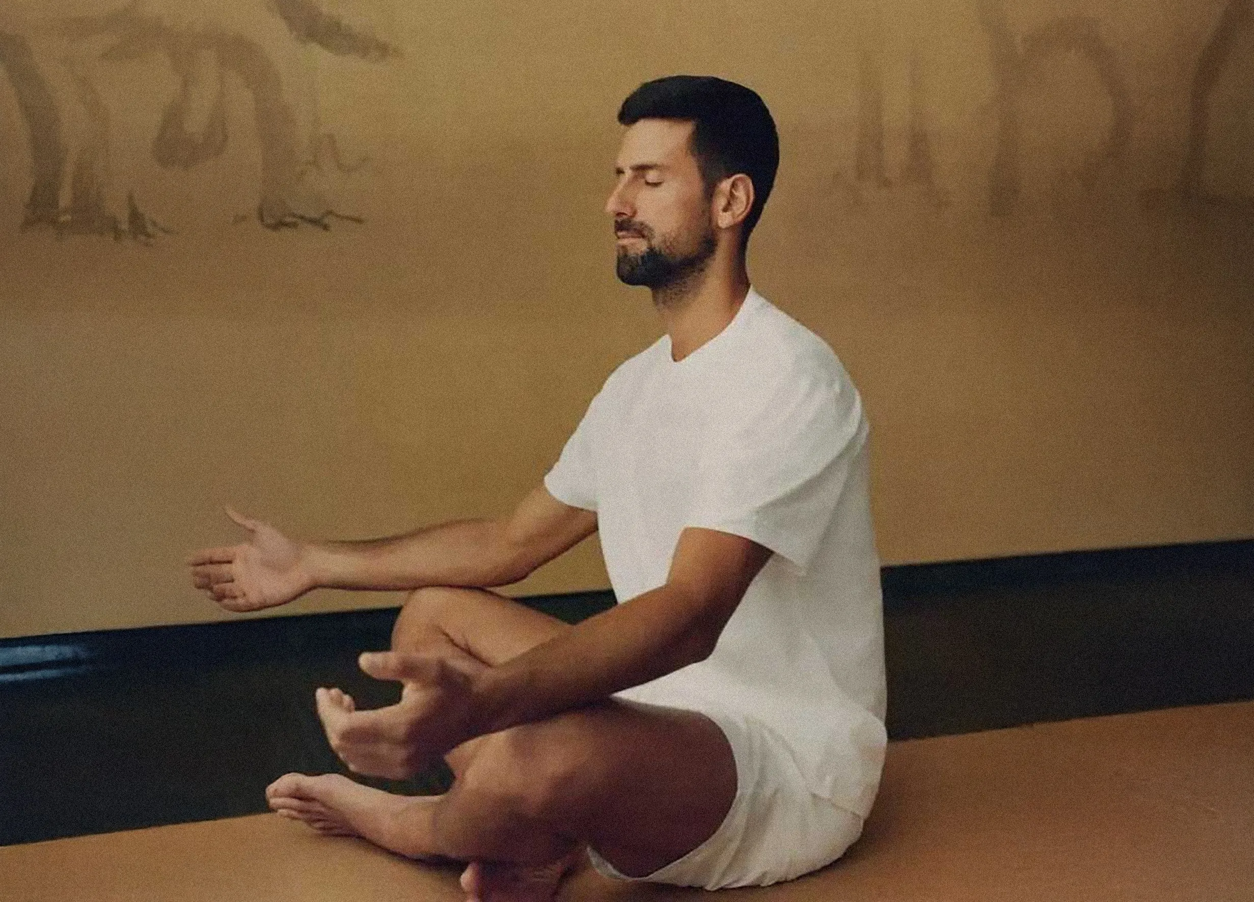 Tennis star Novak Djokovic practising seated meditation at Amanyara in a tranquil indoor wellness space.