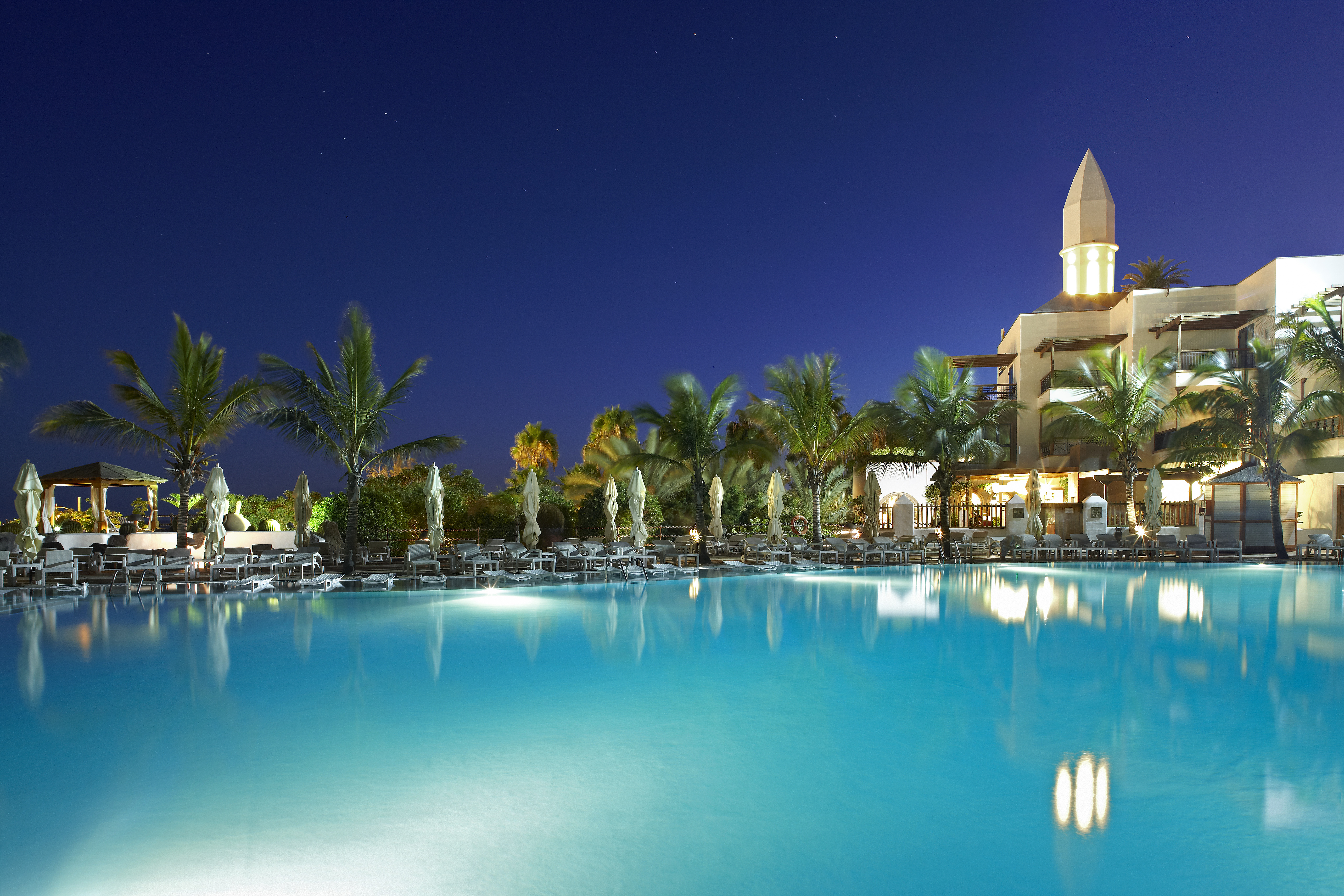 Europe, Spain, Lanzarote, Princess Yaiza Suite Hotel Resort, Sea Water Pool At Night With Minaret