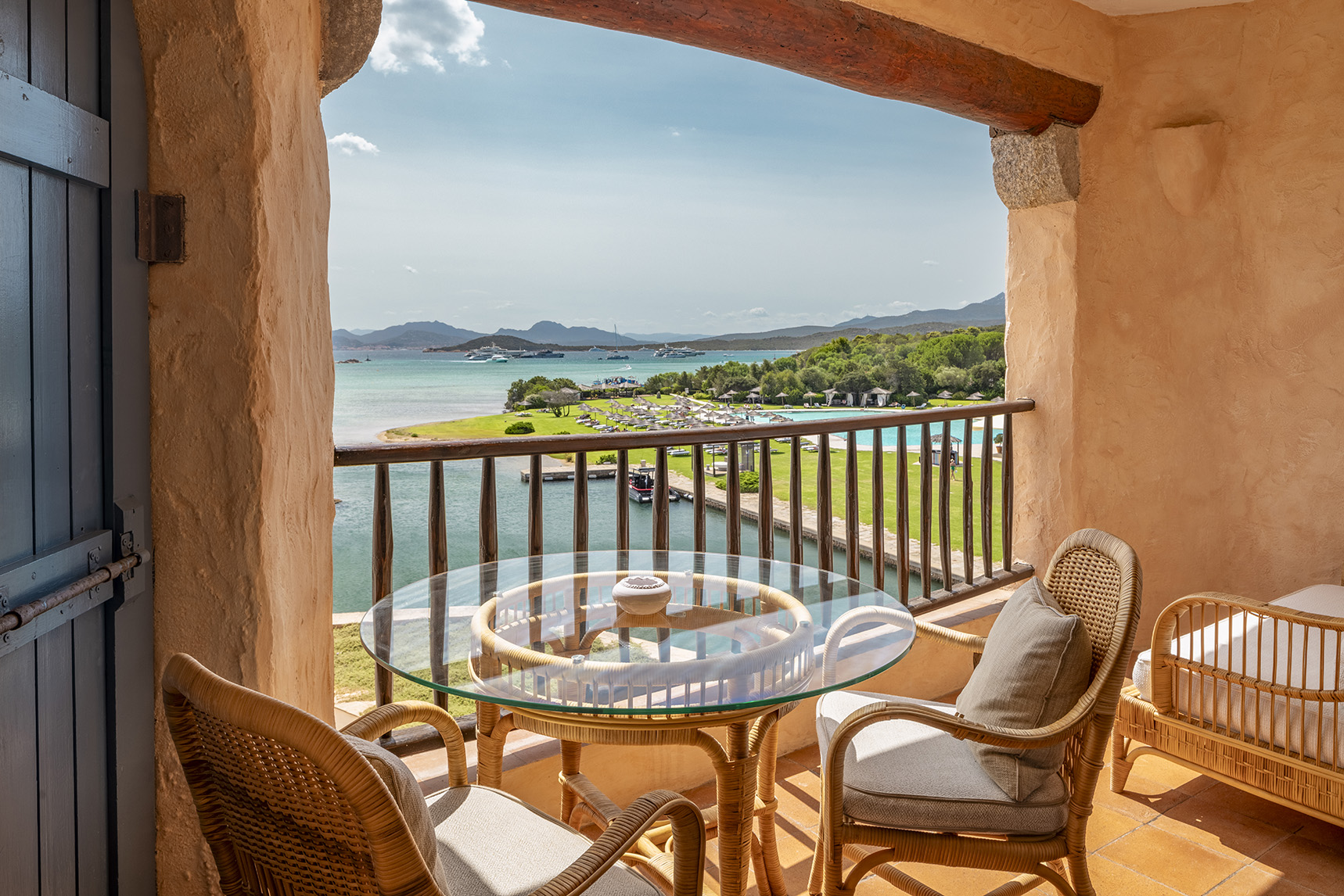 Europe, Italy, Sardinia, Hotel Cala di Volpe, table and chairs beside a Juliet balcony in a Contemporary Premium Double Suite