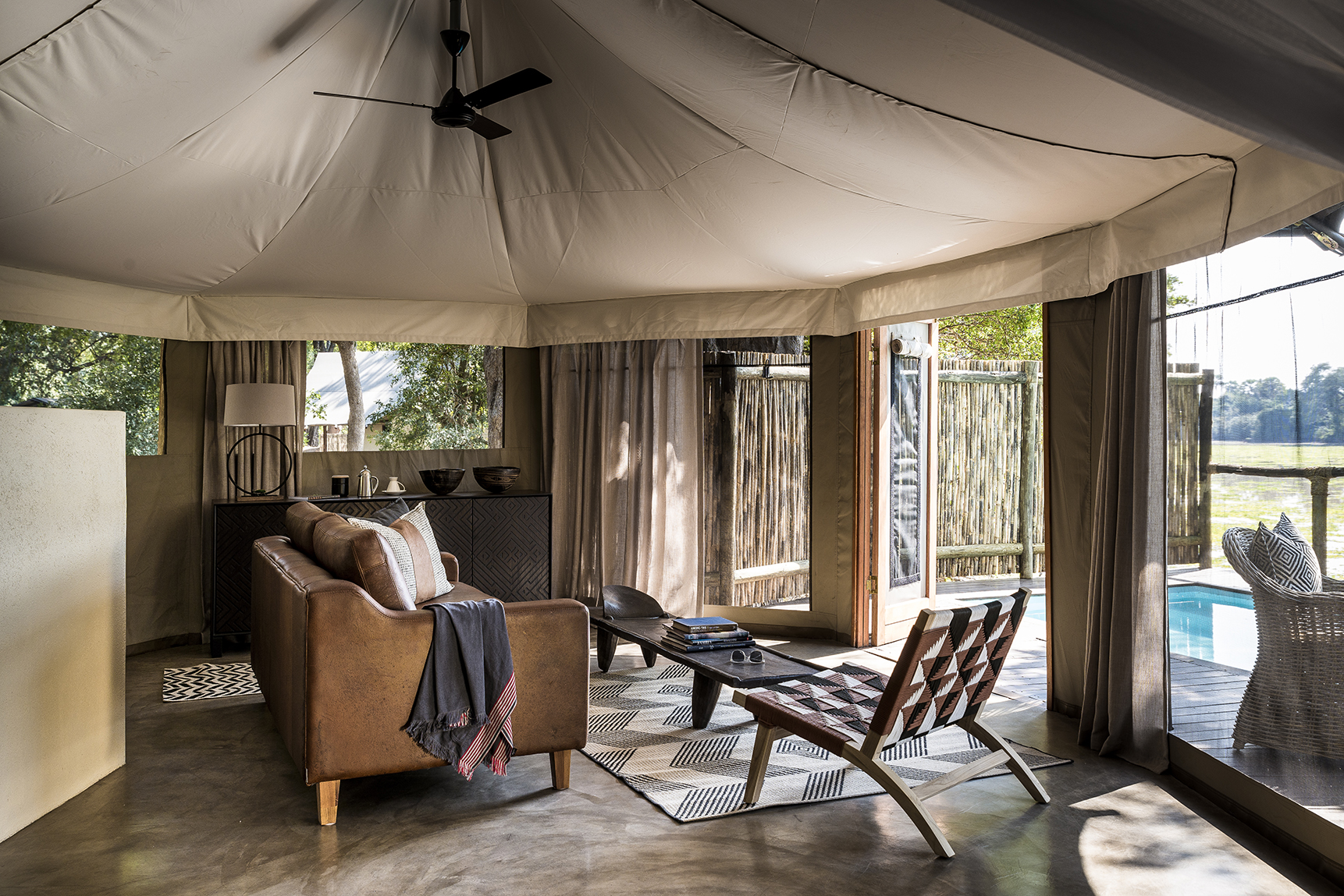 Africa, Zambia, Sungani Lodge, living space in a tented suite made up of a sofa, chair and coffee table