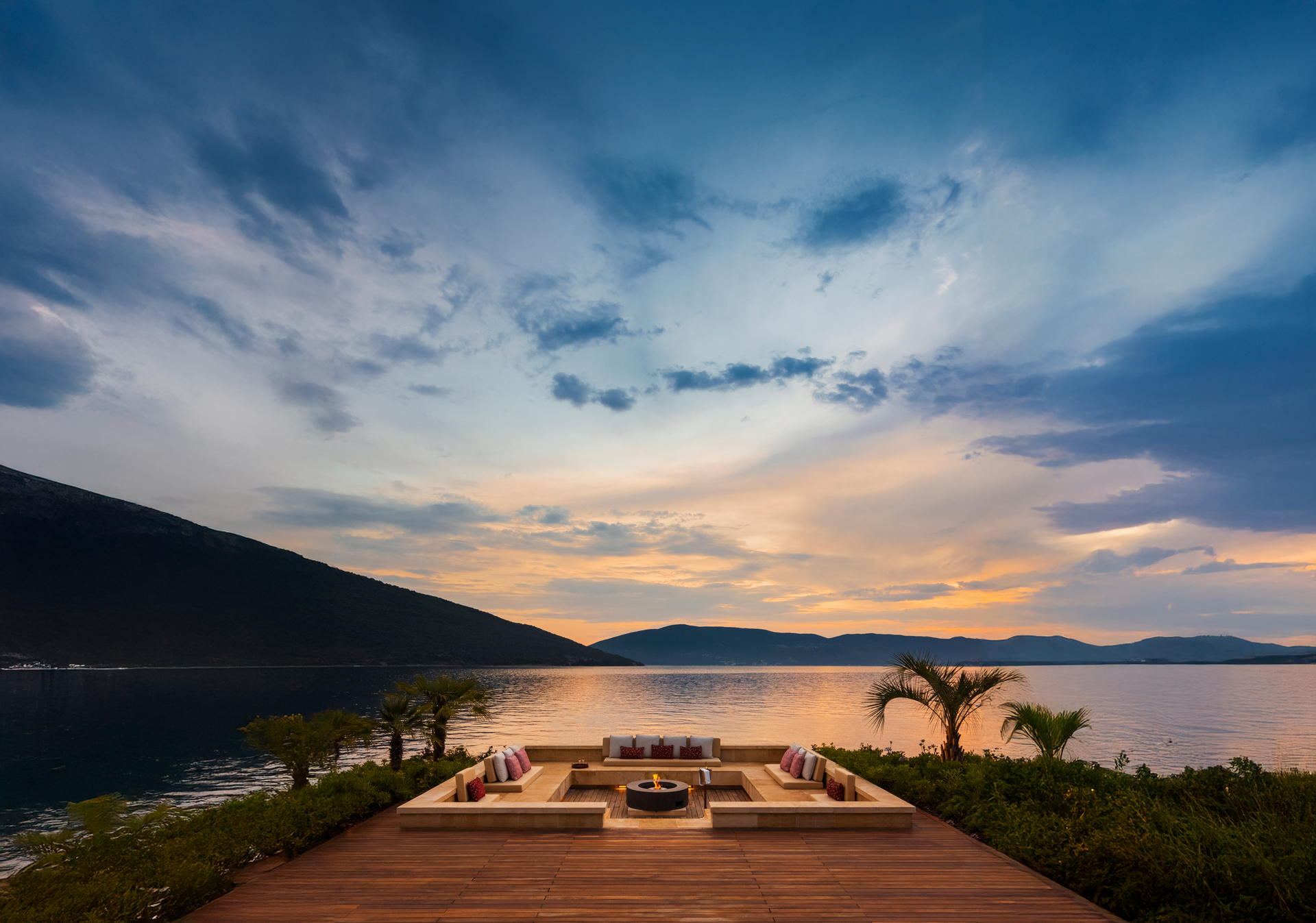 Fire pit sunken into decking by the waterside